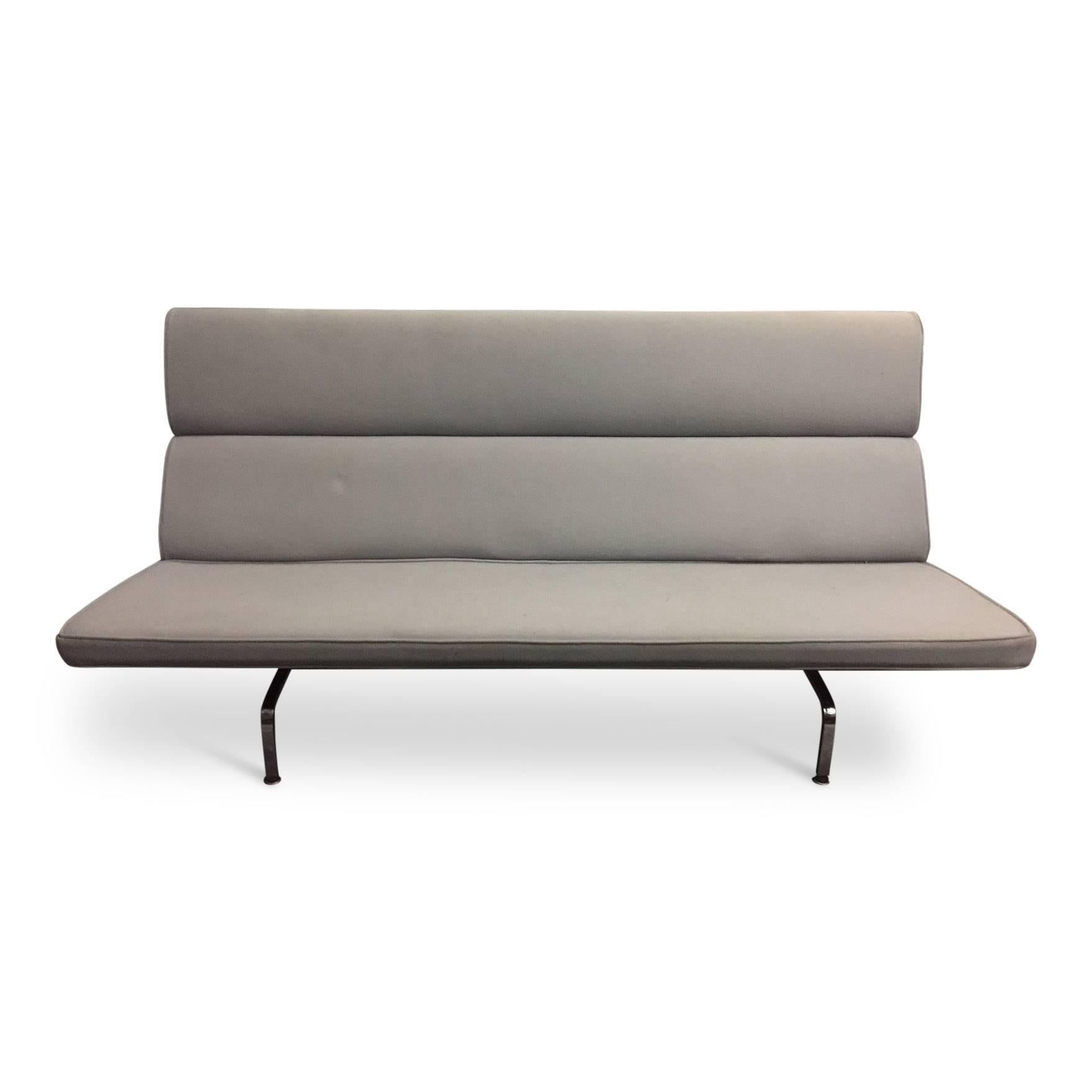 For your consideration is an Eames compact sofa for Herman Miller, upholstered in a grey felt. The slim lines and narrow form of this sofa give it a light and airy feel, excellent for both tight apartments and open spaces alike. Like many of the