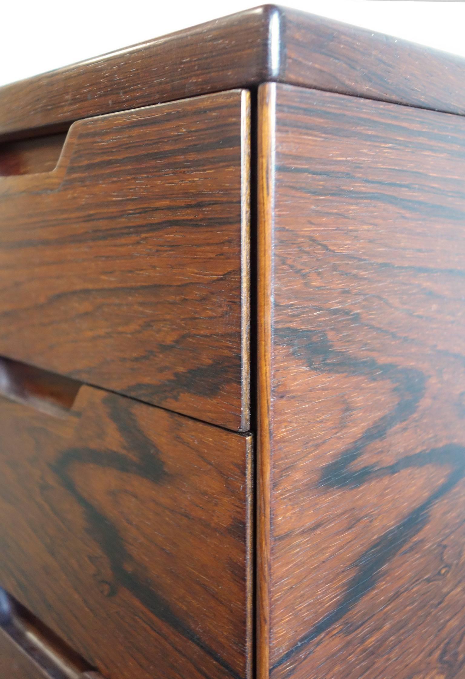 Highly desirable Mid-Century Svend Langkilde for Illums Bolighus rosewood chest of drawers or commode.
Rosewood is highly figured and vibrant. Makers mark affixed to the back. 
One of a pair available.