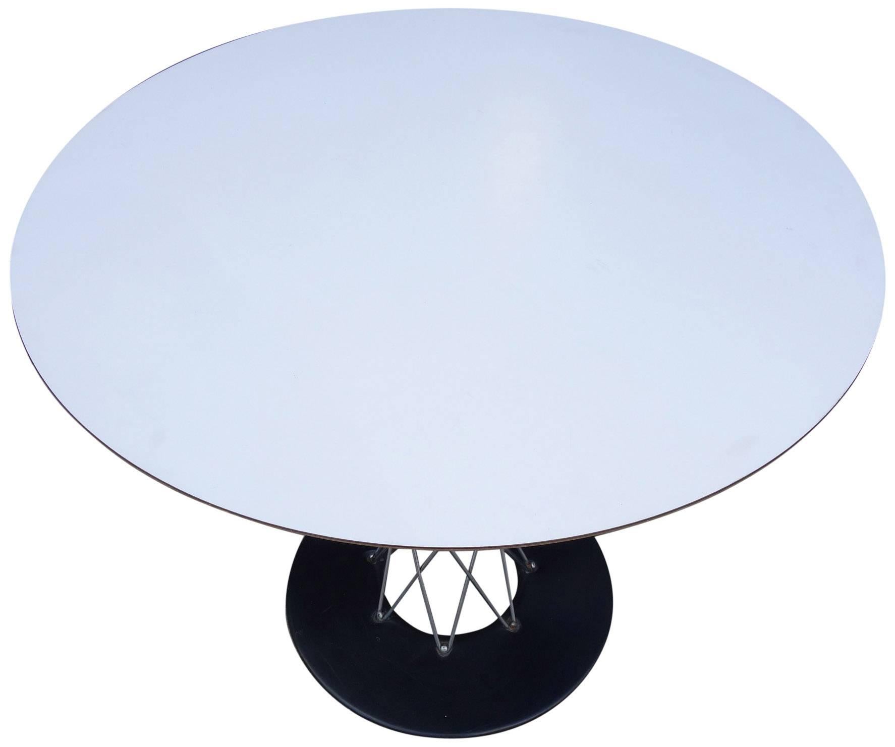 Designed by Isamu Noguchi. The hard to find 35'' diameter top is a perfect apartment size dining, game or kitchen table.

This striking design features a white laminate top with exposed plywood lip. The chromed mid section is anchored by a cast