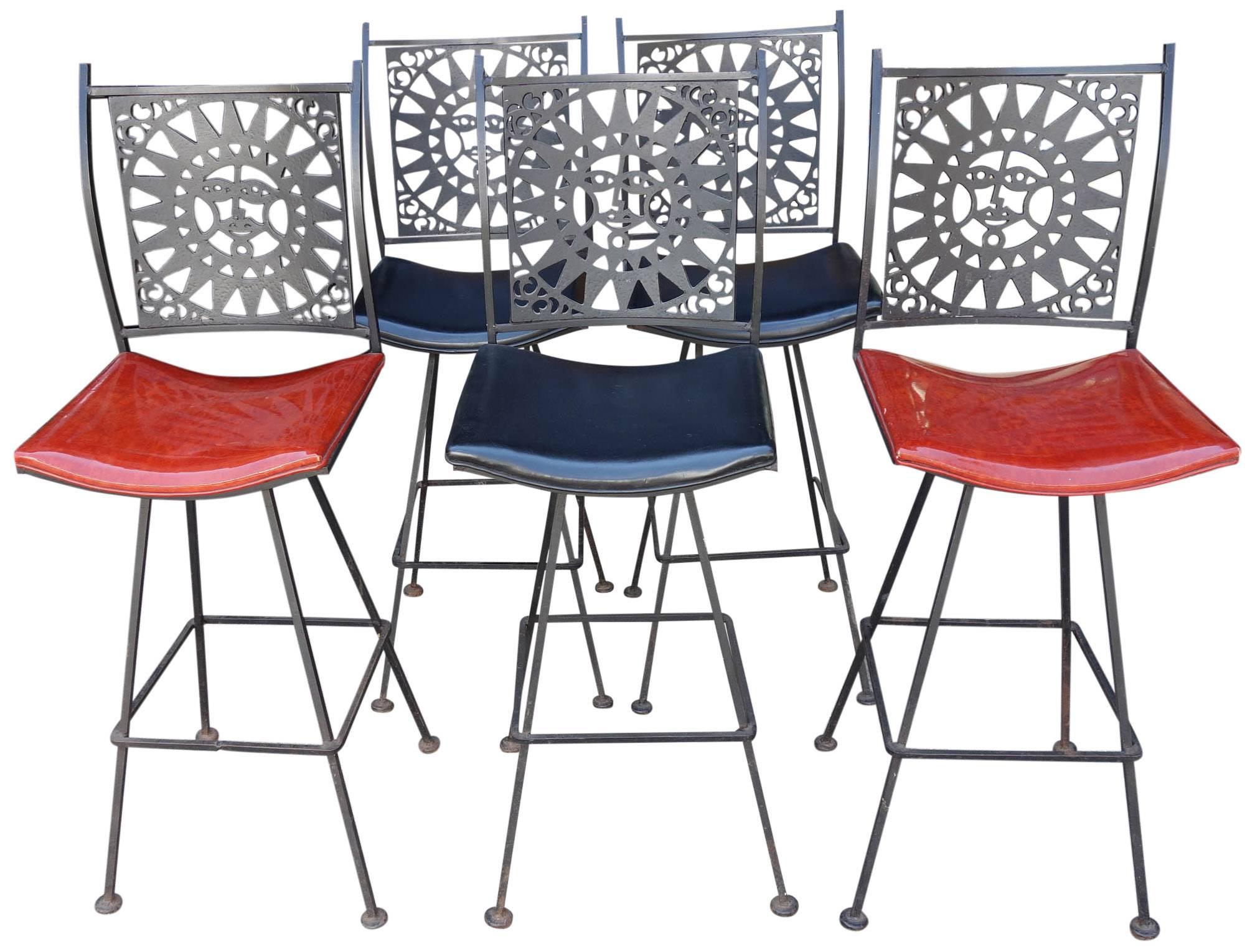 Rare Mid-Century black iron stools with a sun motif. Also in the style of Alexander Girard. Model G-199. The chairs also swivel. Group price discount for all 5