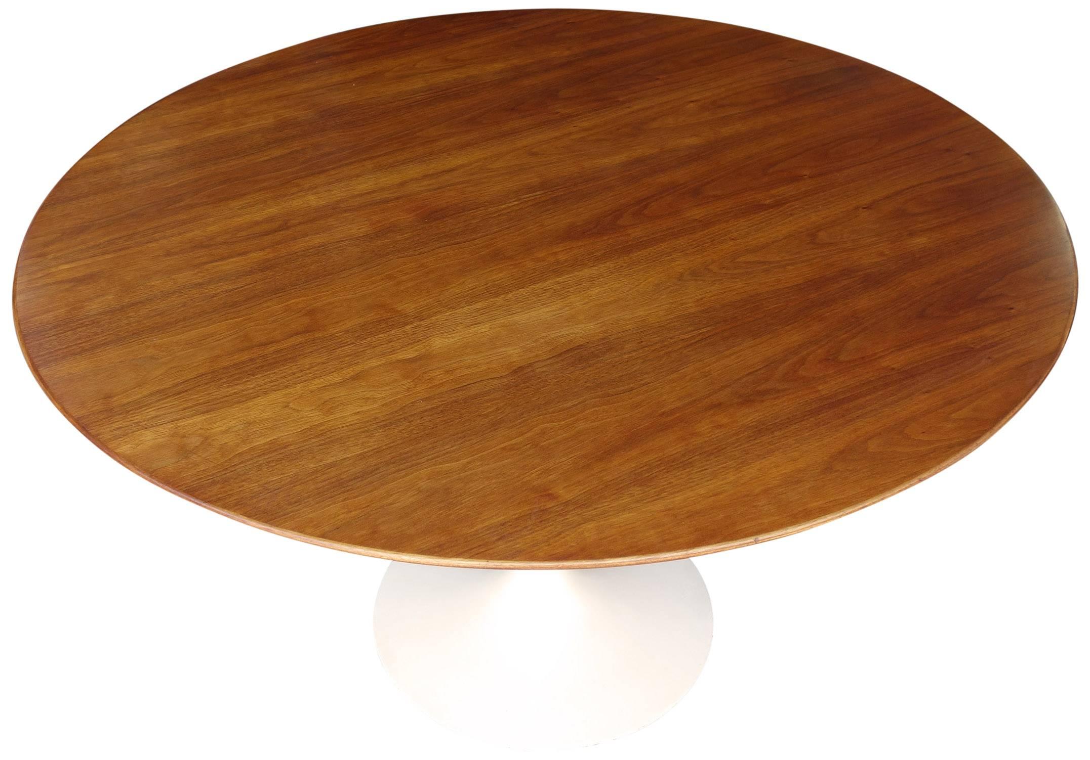 Eero Saarinen for Knoll in walnut on heavy metal base. Wonderful vintage condition. This iconic table was designed by one of the most celebrated artist of that period.
