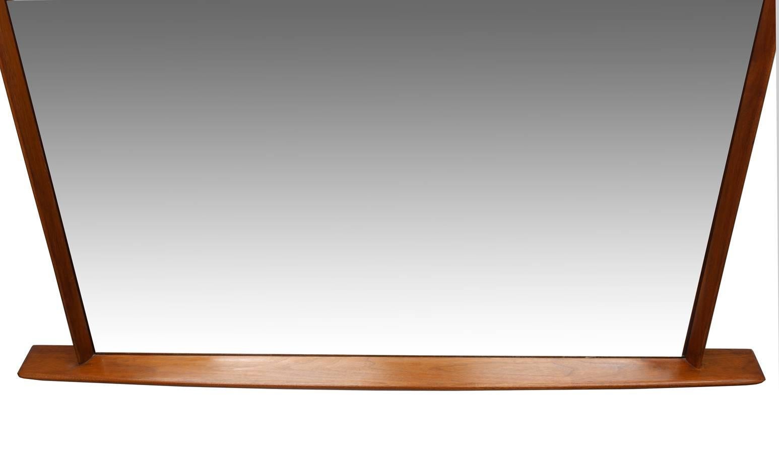 This incredible Mid-Century Nakashima mirror spans 52'' by the base/shelf. Showing a wonderful warm patina and in wonderful condition.