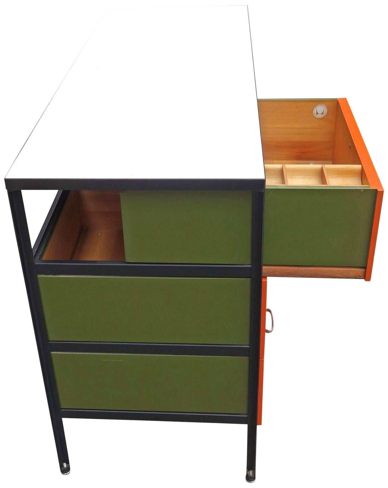 One of our favorites, the George Nelson designed steel frame series is both practical and beautiful. Originally available in many different color combinations the orange / green / black combination in perhaps the rarest. All steel frame cabinets