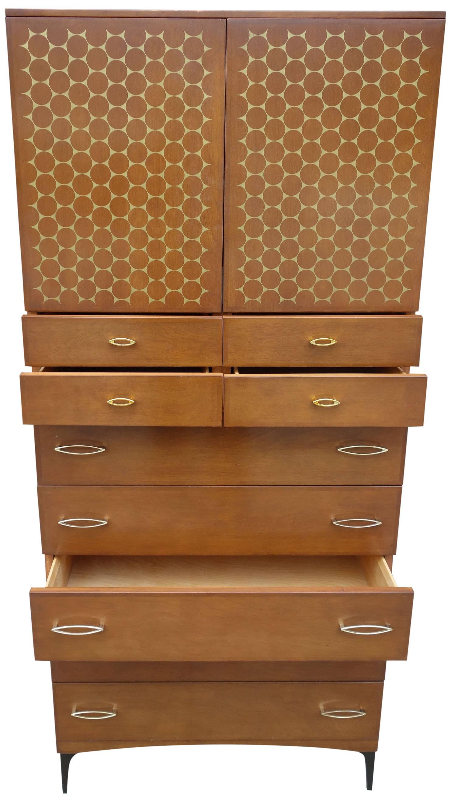Said to be produced for only one year in 1959, the Contessa Line was a strong departure from the blonde wood they are known for. Featuring cherry brown finish with gold accents on metal legs. This rare midcentury wardrobe features four smaller