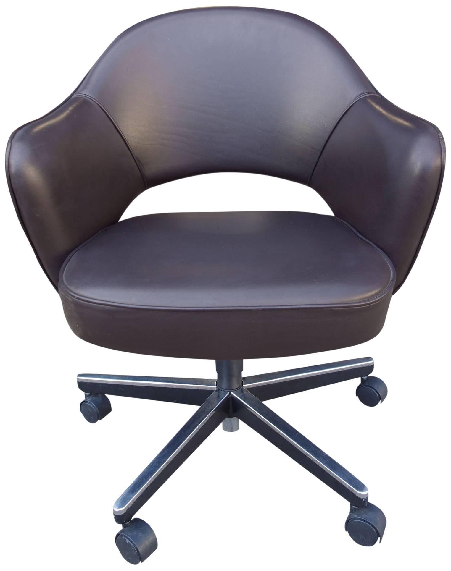 Classic Saarinen armchairs on casters with height and tilt adjustments. Chocolate brown leather. Up to 6 available.