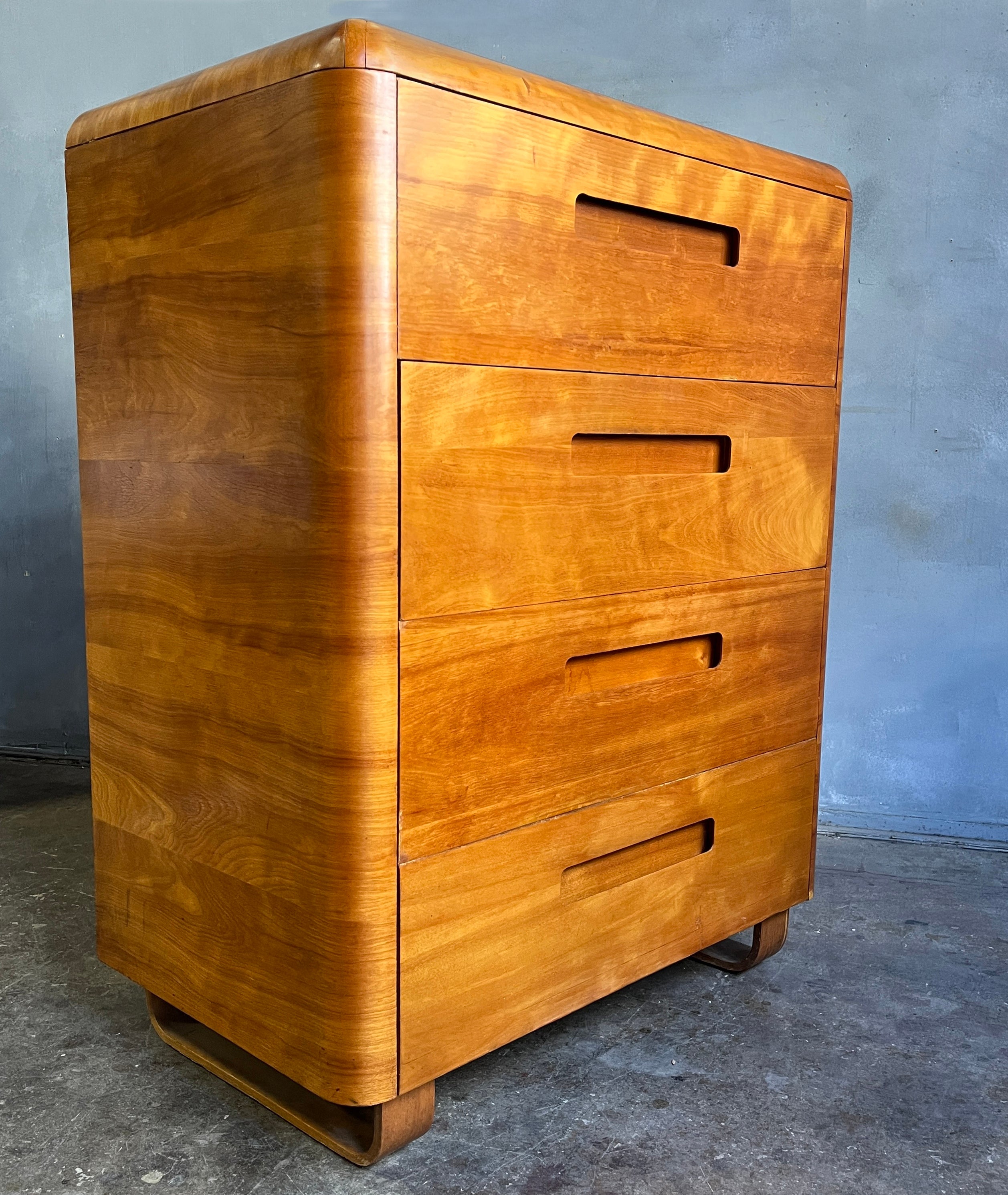 Beautiful shimmering birchwood 4 drawer dresser on sled base. Produced by Plymold for just a few years before founding Plycraft. Paul Goldman designed most of Plycraft furniture including the iconic Cherner Pretzel chair as well as designing for