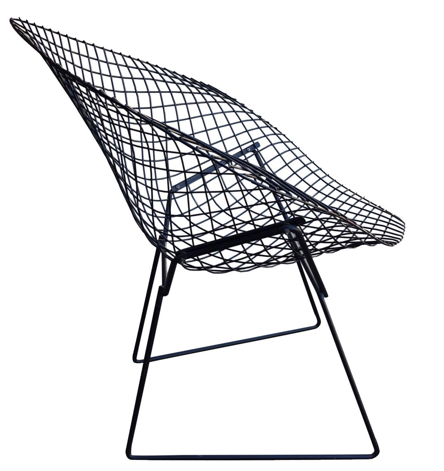 Knoll started production of Harry Bertoia's Diamond chair in the early 1950s. Since then it has become one of the most iconic designs of Mid-Century Modernism. The welded black steel frame is in excellent condition. This chair has been upgraded with