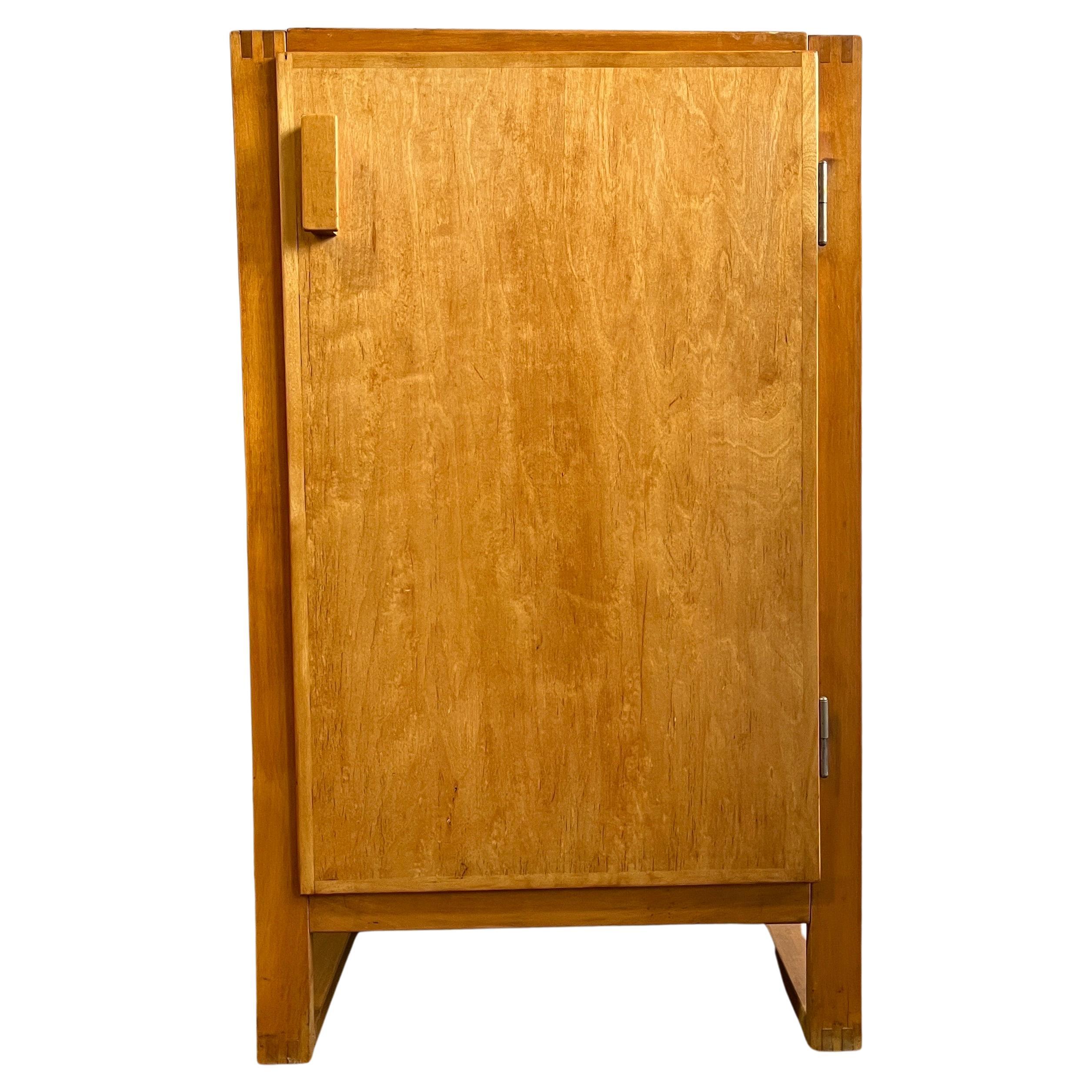 Midcentury cabinet featuring an internal middle shelf on sled base. Beautiful finger joints and brass screw details with original patina. Very solid handsome piece that would pair well with Mccobb, Eames, or Aalto designs.

    