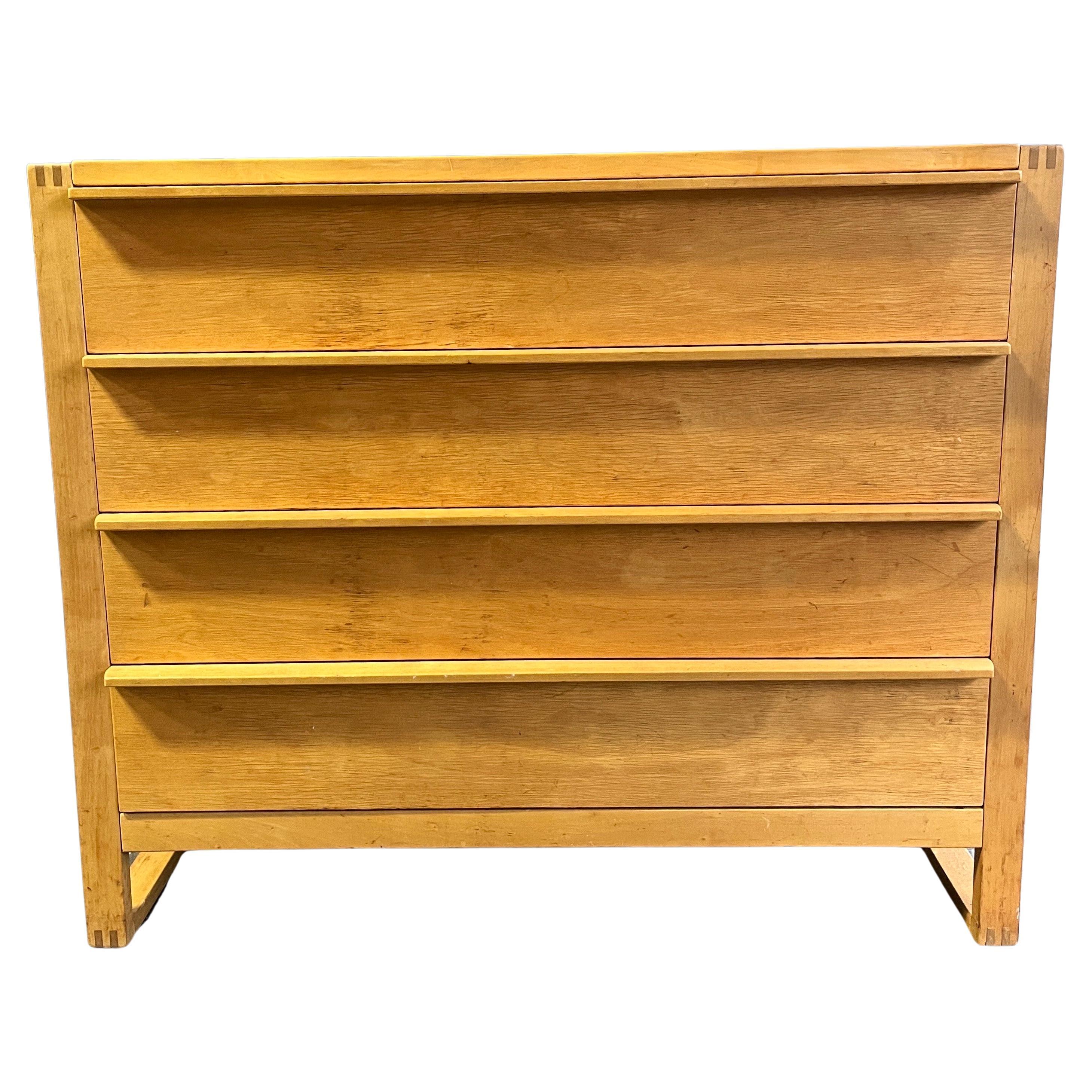 Mid-century chest of drawers featuring four shelves of equal proportions on sled base. Beautiful finger joints and brass screw details with original patina. Very solid handsome piece that would pair well with Mccobb, Eames, or Aalto designs.
