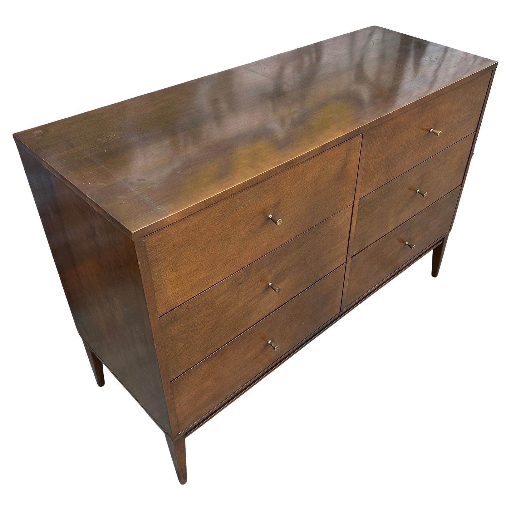 Vintage midcentury Paul McCobb six-drawer dresser credenza Planner Group #1509. Beautiful dresser by Paul McCobb circa 1950s Planner Group, 6 drawer, solid maple wood Walnut finish, brass pulls on wood base base. Original vintage condition with