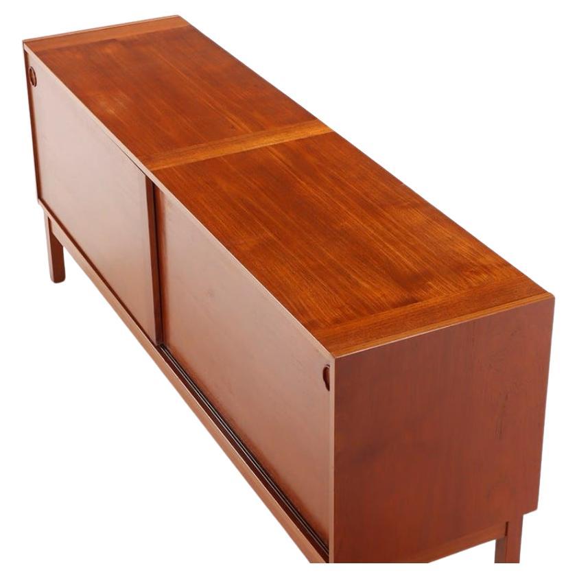 Danish modern credenza with sliding doors and 3 adjustable shelves by ib Kofod Larsen. Circular door slide handles. Minimalist design.
Made By Faarup Møbelfabrik made in Denmark. Located in Brooklyn NYC

Dimensions 72” x 19” x 30” high