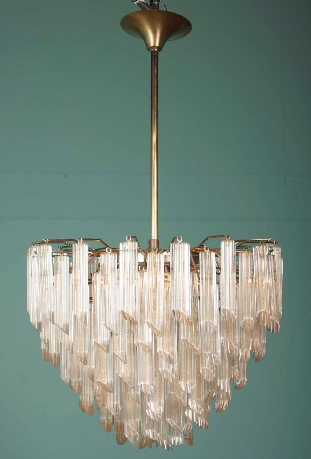 A magnificent Italian Mid-Century Modern chandelier of tiered Murano glass prisms with gold inclusions by the Camer Glass Company from the 1970s.

Dimensions: 36