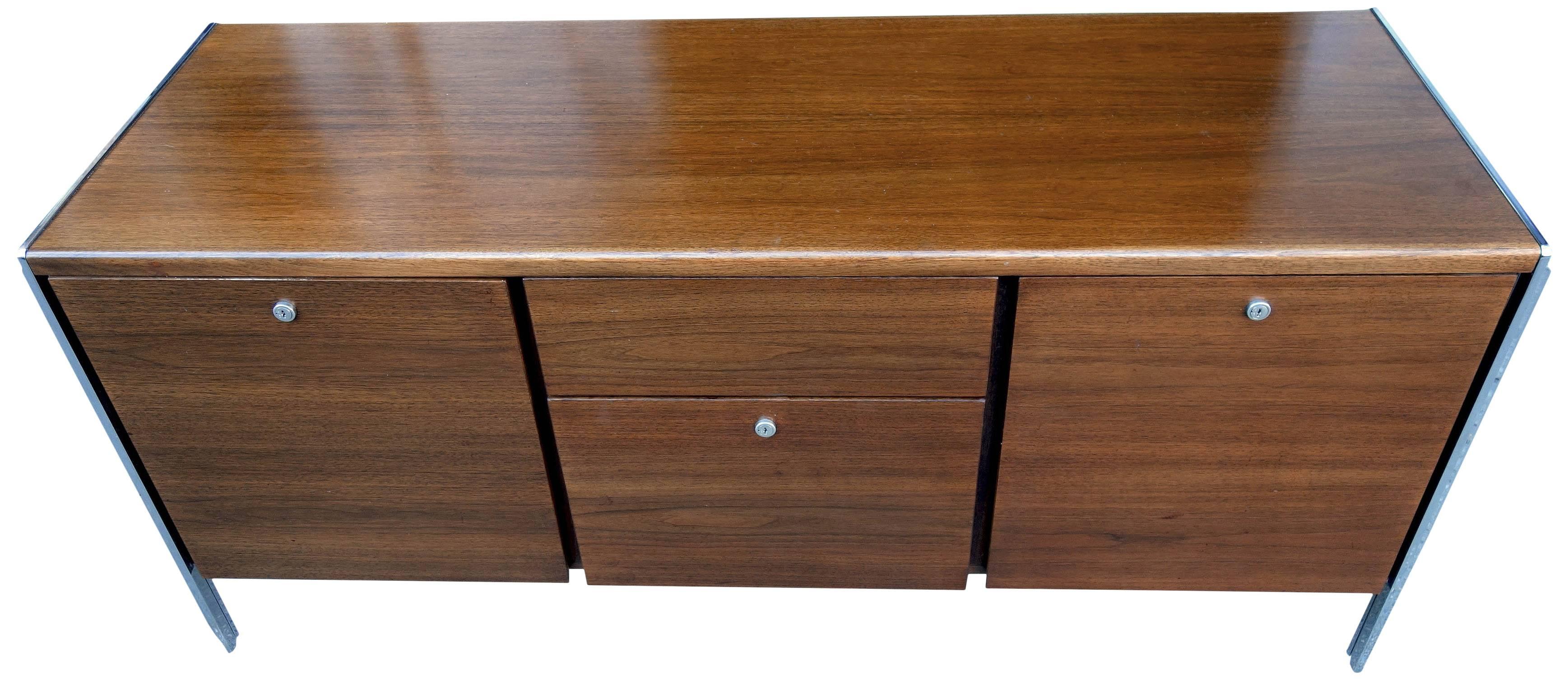 Sleek midcentury credenza / cabinet by Stow and Davis accentuated by chrome accents. Originally from an executive office with Knoll and Stow & Davis furnishings. A very solid case piece.