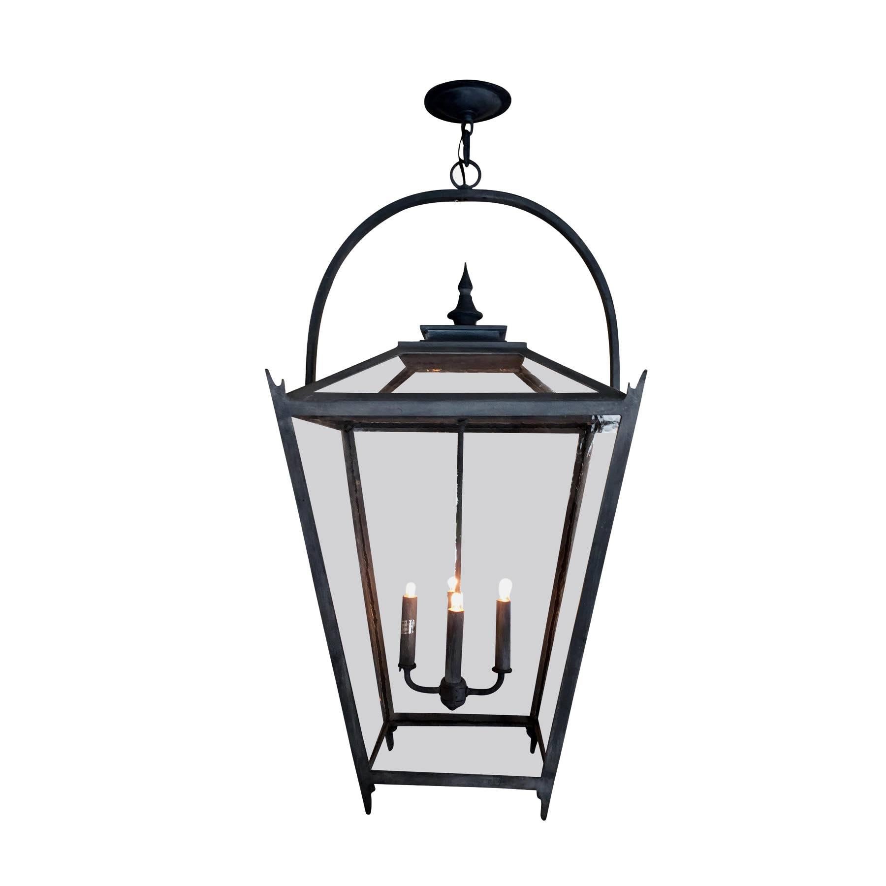 This vintage inspired wrought iron pendant exudes classic styling and minimalist beauty with a traditional tapered shape, glass roof and embellished top.  Perfect for lighting kitchen islands or covered verandas and porches.  Created in