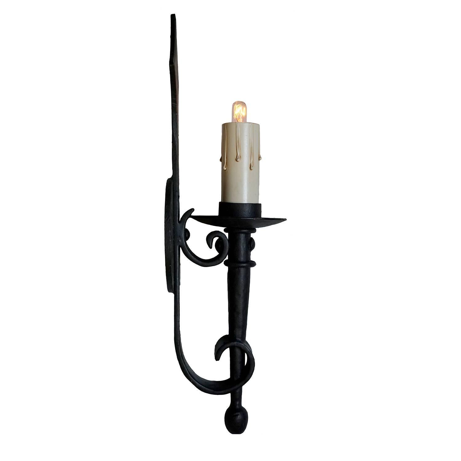 This wrought iron arm mount fixture has a classic French influence, with simple scrolls and a diamond motif on the backplate.  A perfect sconce for many architectural styles, including Spanish Hacienda, Mediterranean Villa and French Colonial. 