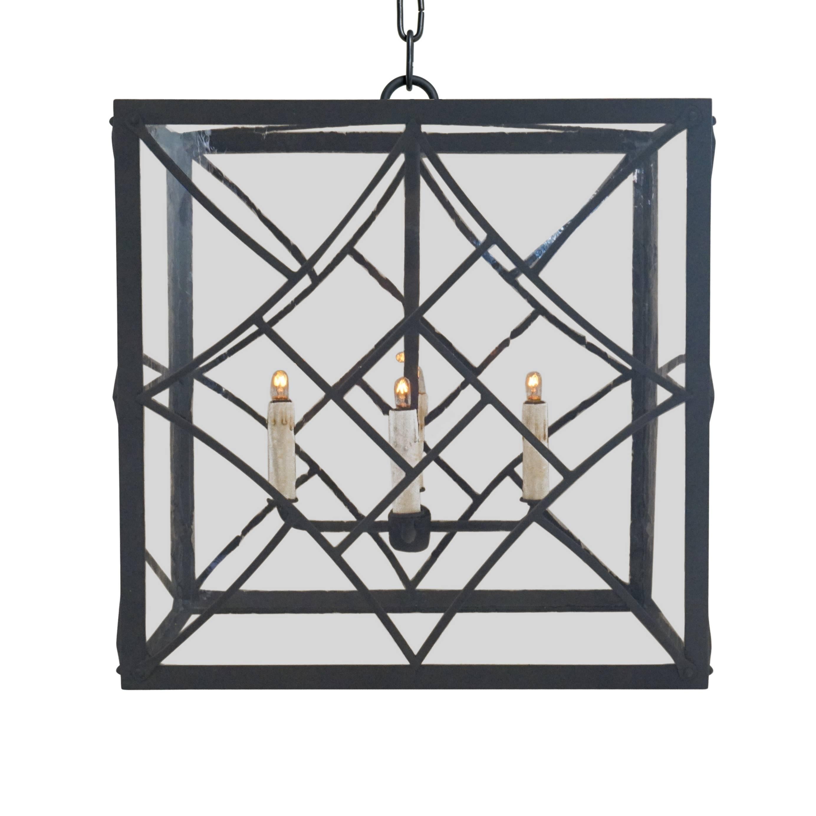 Evoking the Art Deco style of the 1920s and 1930s, our Nouveau pendant features bold geometric shapes and a chevron motif. Handcrafted in wrought iron with a Classic grey finish. Antique glass pairs well with the Mid-Century Modern design, providing