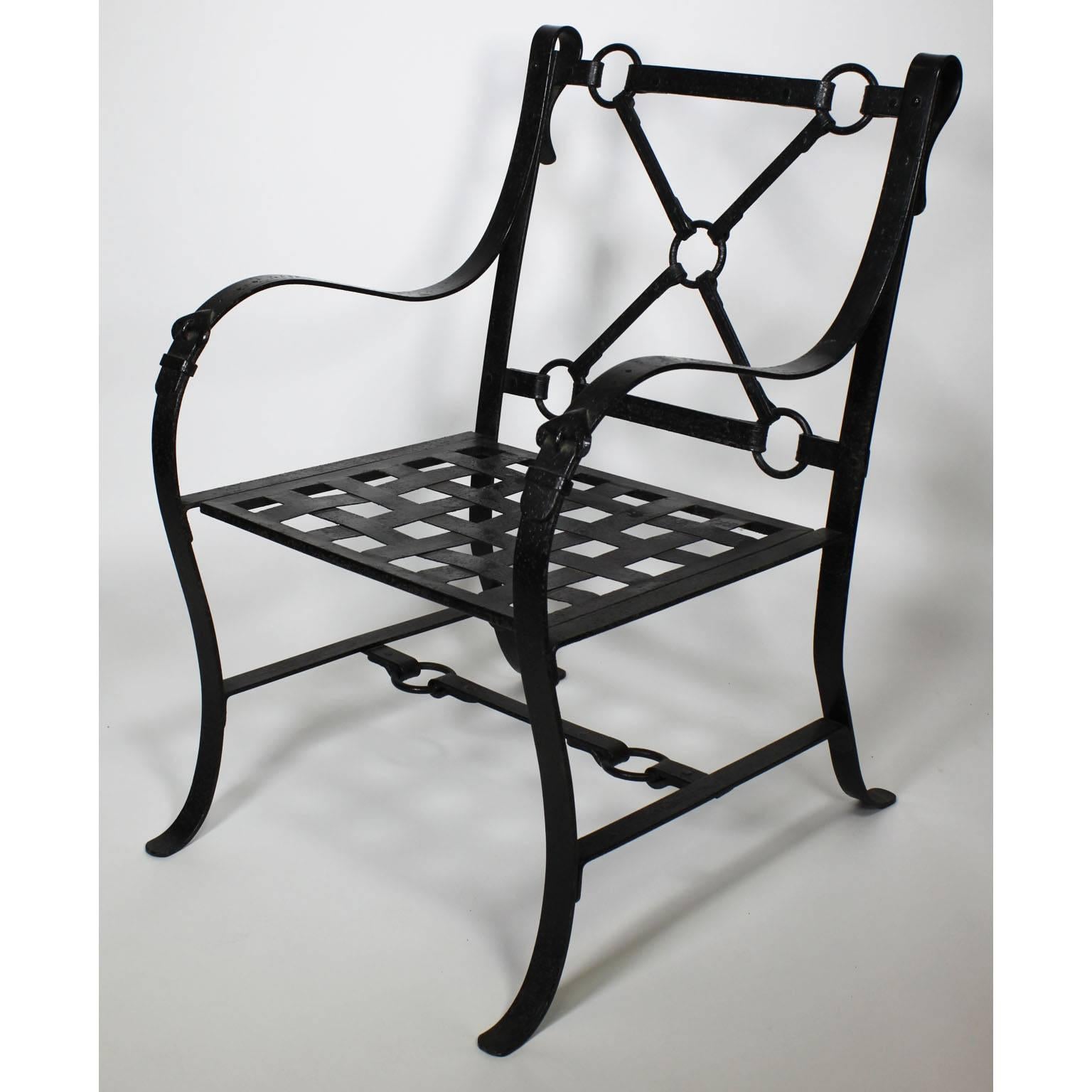 A rare pair of French Mid-Century designer ebonized metal painted armchairs with forged decorative castings representing faux leather equestrian strap straps with buckles and rings, each coated with a sandy black enamel, in the manner of Jacques