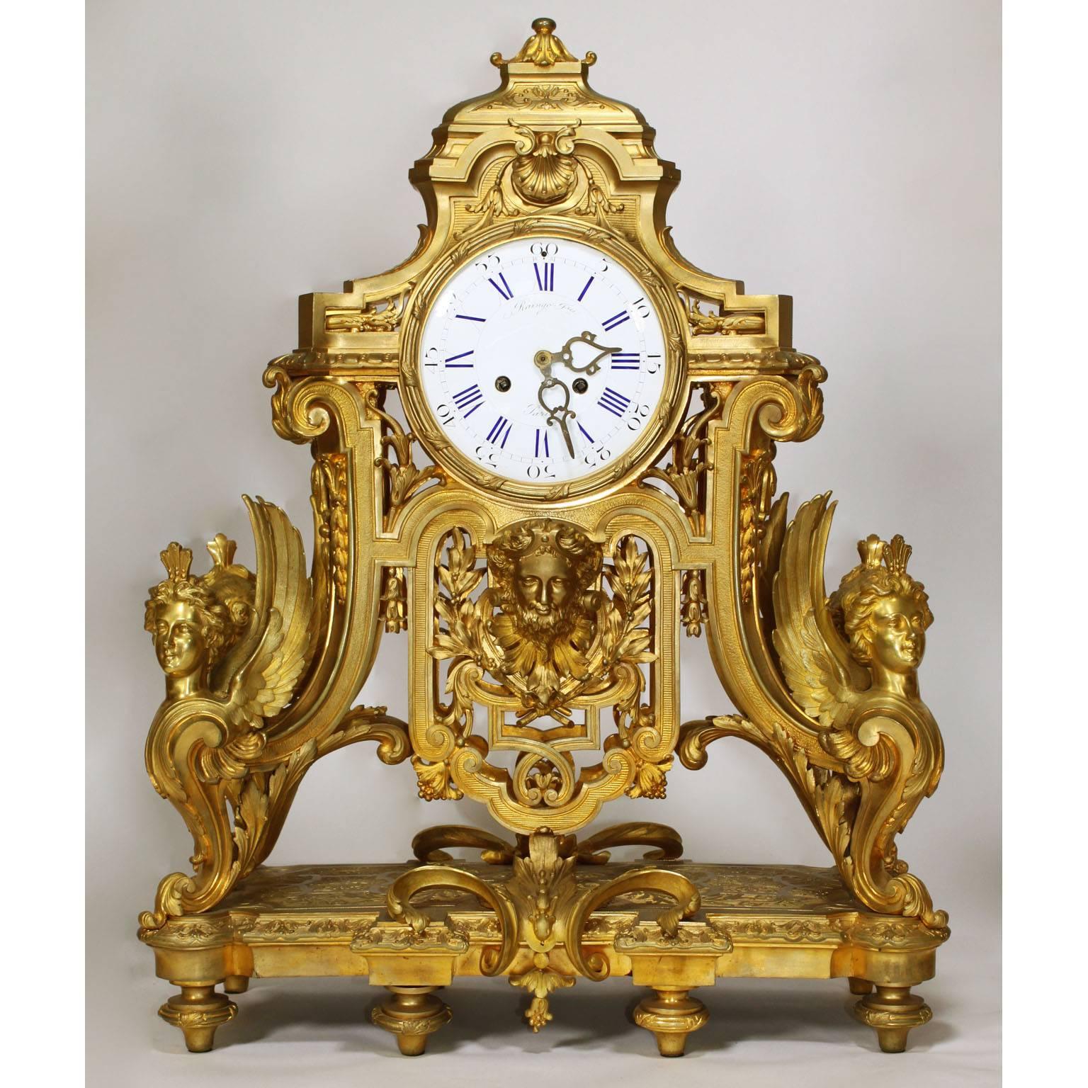 A very fine and palatial French 19th century Louis XIV style figural ormolu three-piece clock and candelabra garniture suite, comprising of a gilt-bronze clock and a pair of ten-light candelabra. The finely chased gilt-bronze clock with a domed top,