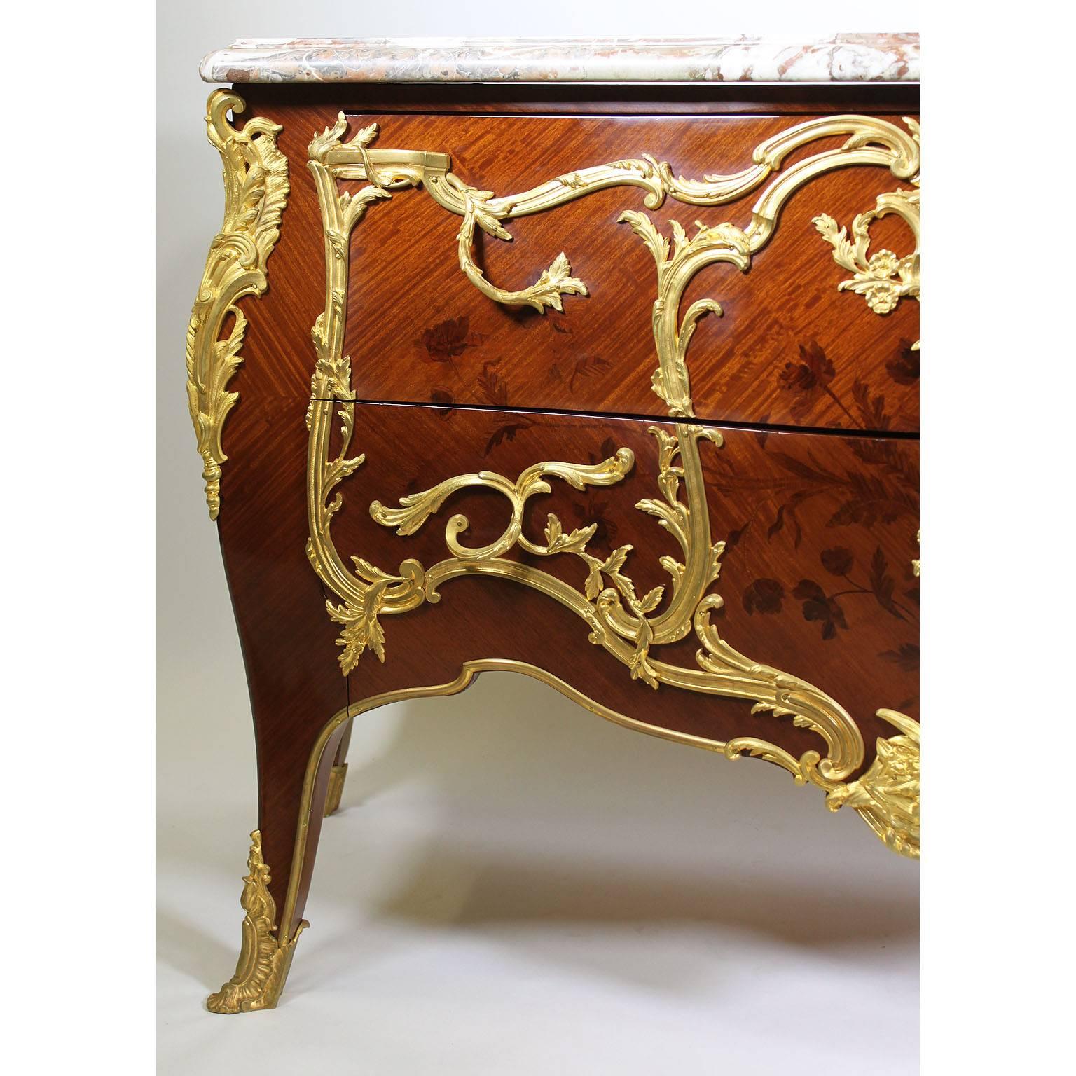 A fine French 19th-20th century Louis XV style gilt bronze-mounted kingwood, amaranth, satinwood and Tulipwood Bois Satiné and Bois de Bout Floral Marquetry Two-Drawer Commode of bombé serpentine form, with a veined Rouge Roayl marble top above two