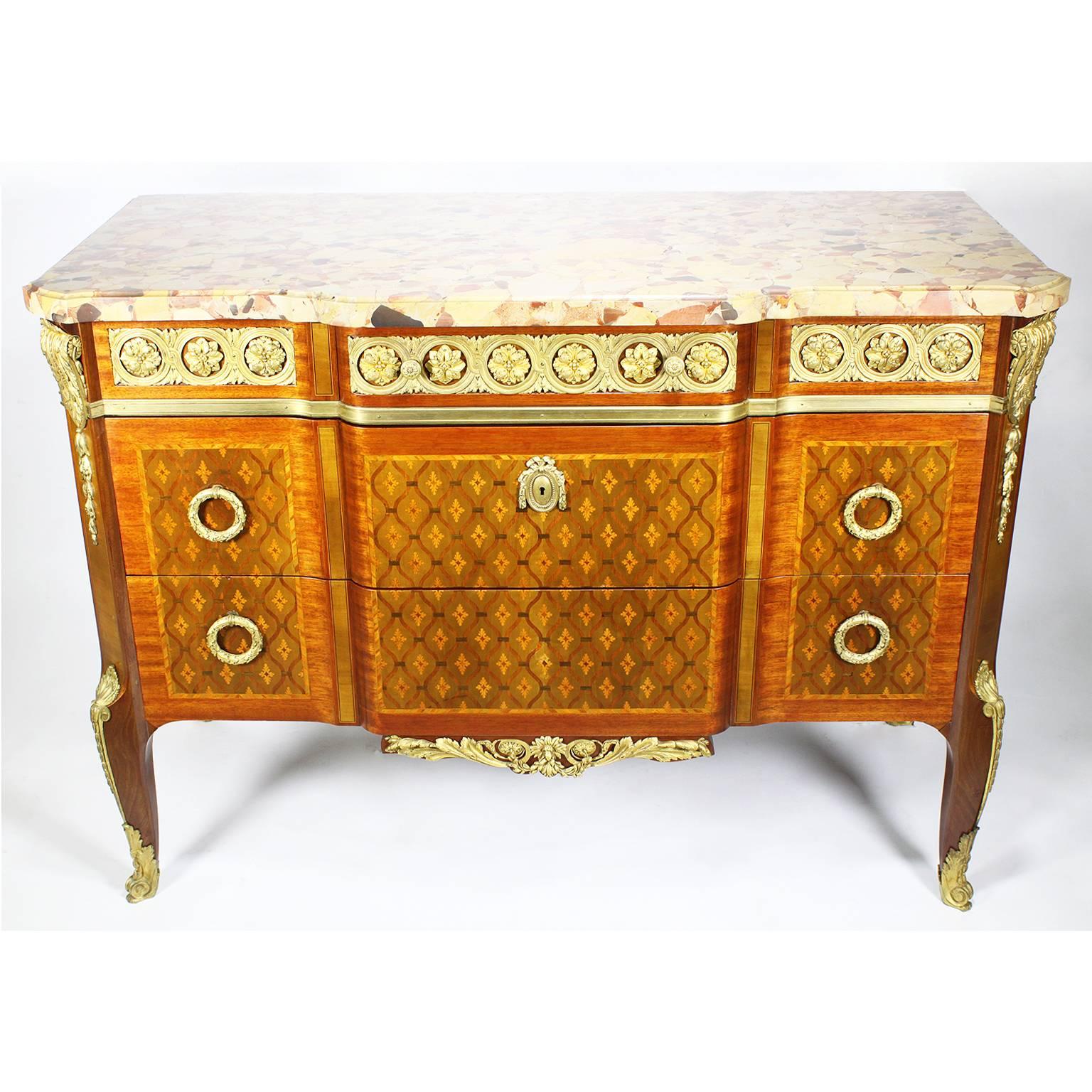 A very fine French 19th century finely chased ormolu-mounted Regence style kingwood, tulipwood and satinwood marquetry and parquetry commode with brêche d' alep marble-top. The serpentine front with three large drawers with ormolu ring pulls and a