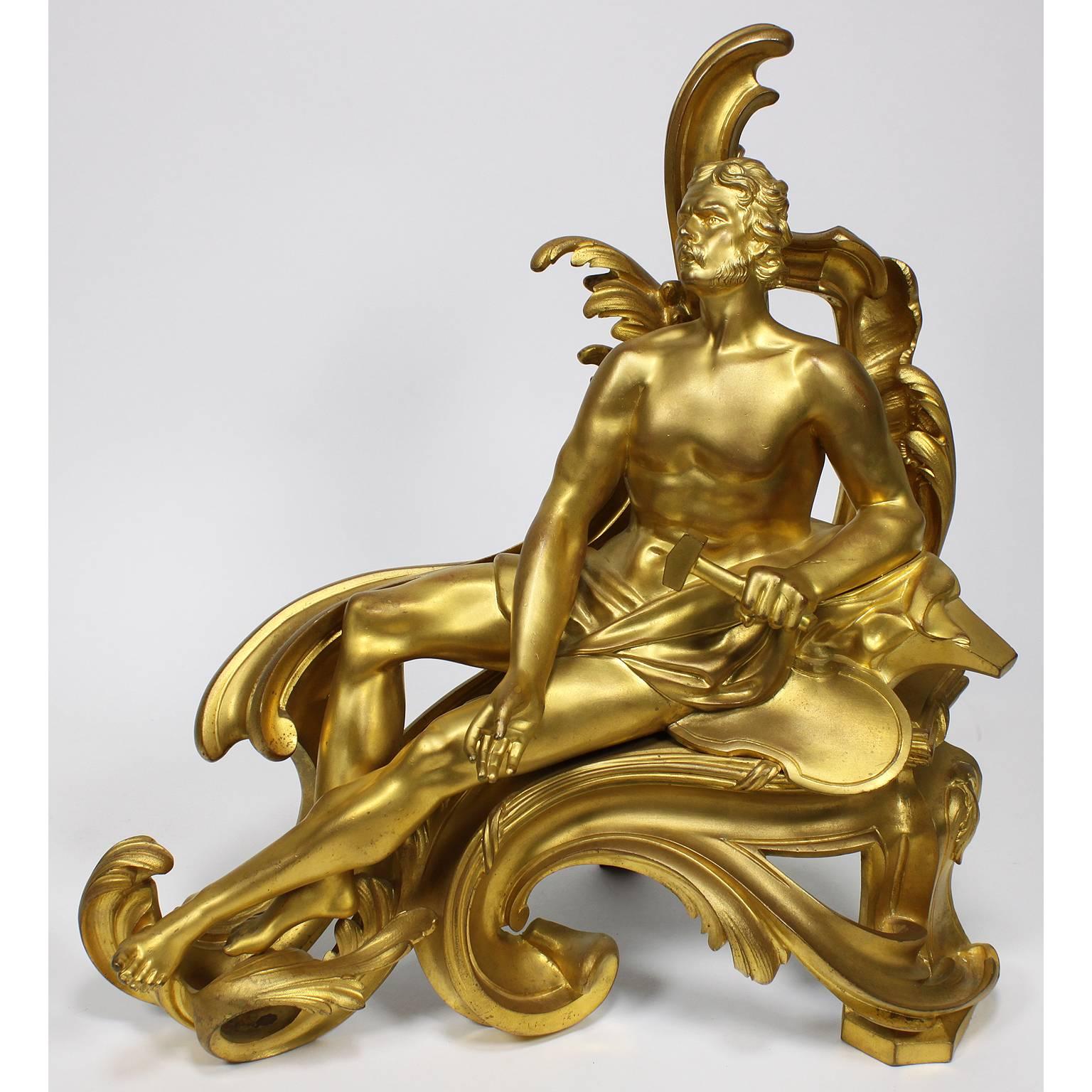 A fine pair of French 19th century Louis XV style gilt bronze figural chenets (Andirons), each depicting a classically draped reclining figure, one male holding a Hammer and the other a nude female feeding a bird, both on a scrolled foliate cast