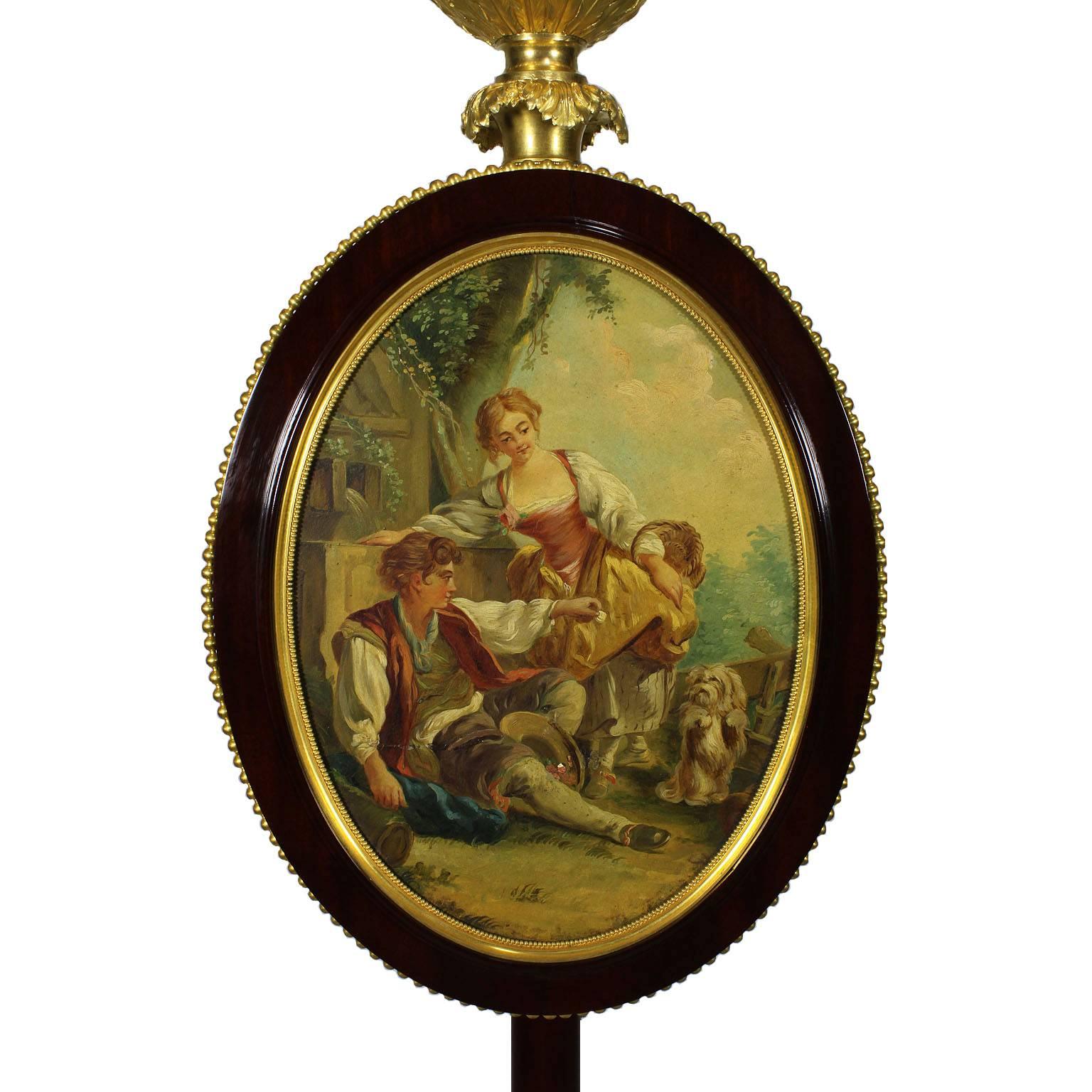 A very fine and rare French 19th-20th century louis xv style figural mahogany, Paris porcelain and ormolu-mounted floor oil-lamp, centred with an oval oil on canvas painting 