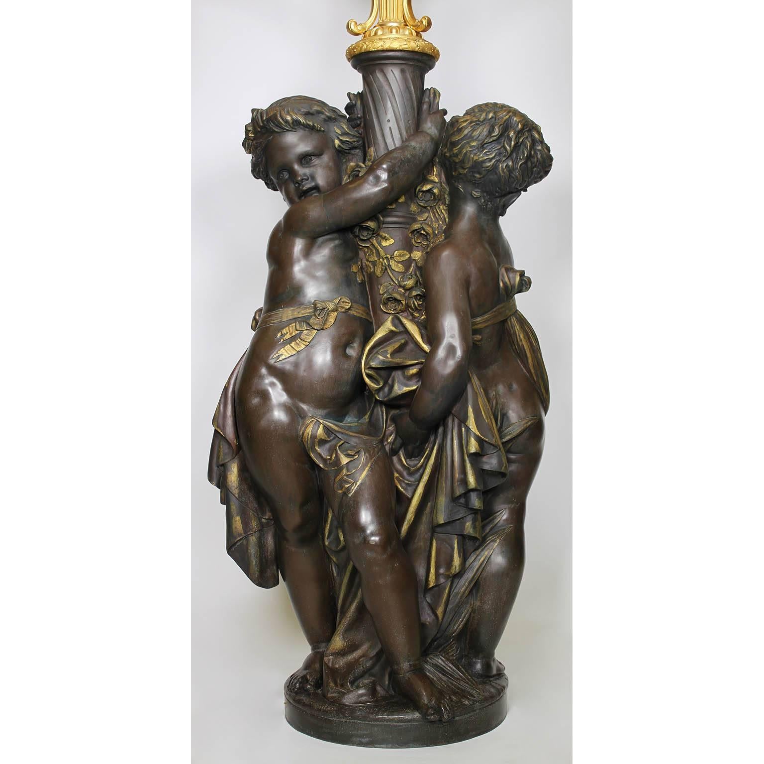 A very fine and large Museum Quality french, 19th century Versailles Style Figural Torchère with two side-by-side Putti in a Brown and Parcel-Gilt Patina Holding a Four-Light gilt bronze Candelabrum with Frosted glass flame shades, by Lacarrière