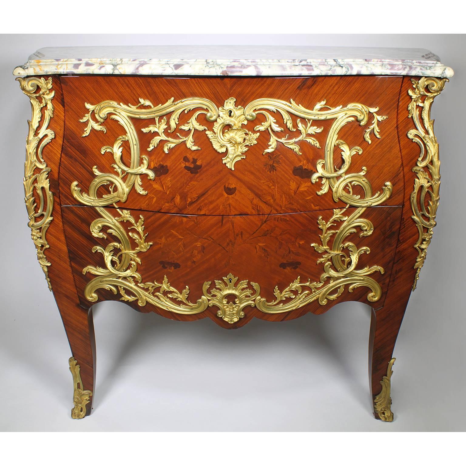 A fine semi-pair of French 19th century Louis XV style gilt bronze-mounted tulipwood, kingwood and Satinwood floral marquetry Bombé commodes with a Brêche Violette marble top. The serpentine two-drawer commodes with bowed front and sides, surmounted