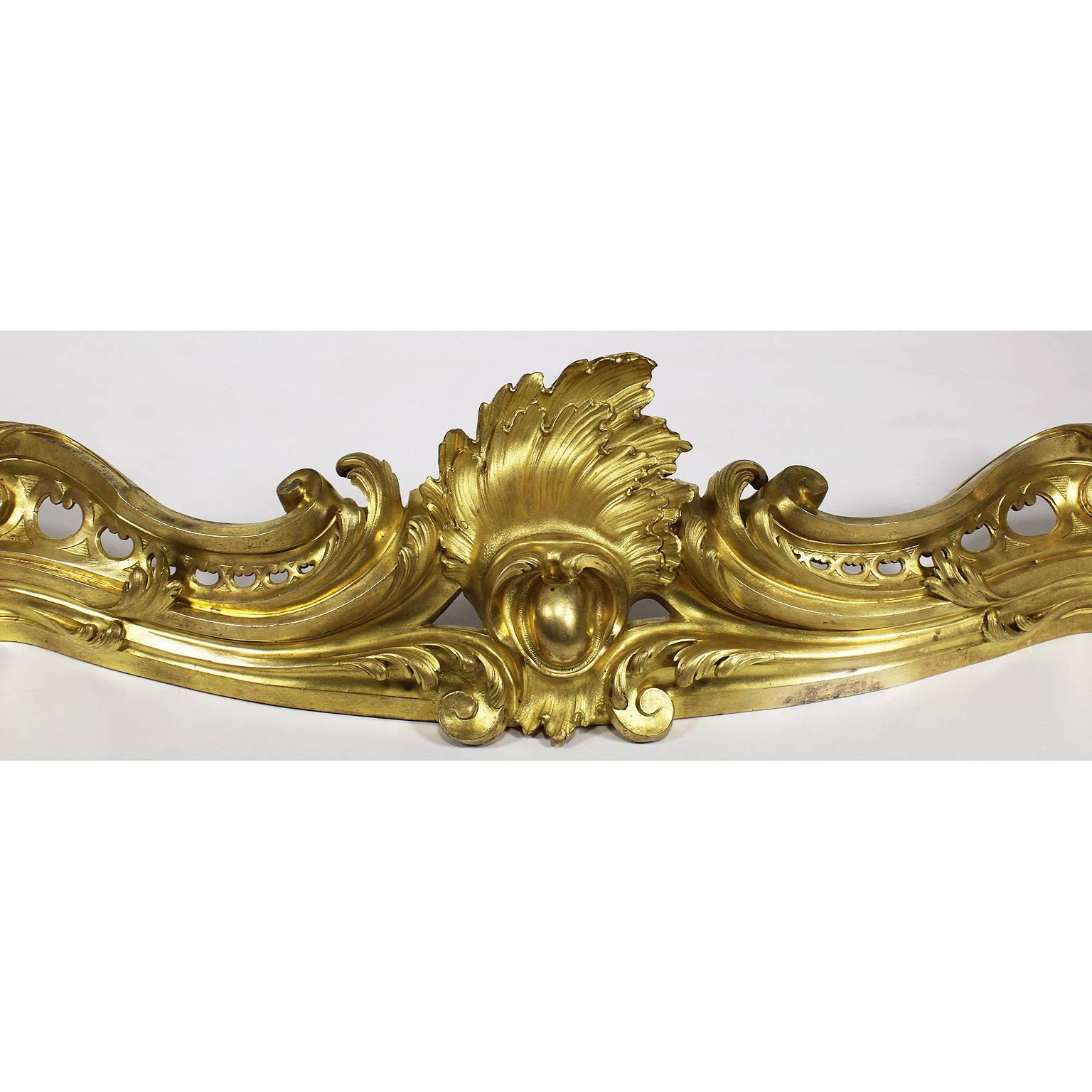A fine French Belle Époque ormolu fireplace Mantel Andiron Fender, attributed to François Linke (1855-1946) and probably designed by Léon Messagé (1842-1901), of serpentine form, cast with pierced scrolls, shells, shields and acanthus. A truly