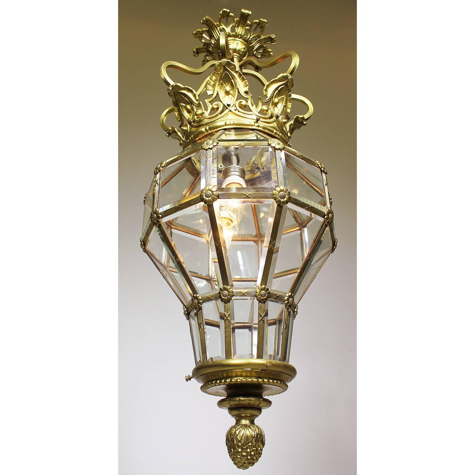 A French early 20th century gilt-metal paneled beveled glass 