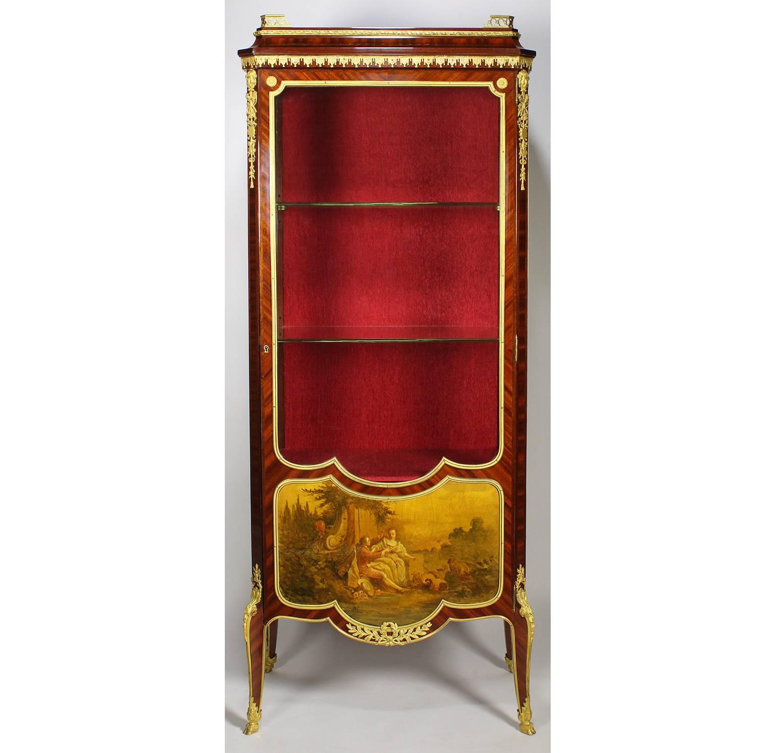 A very fine French Belle Époque 19th century tulipwood and gilt bronze-mounted Vernis Martin decorated Vitrine by Louis Majorelle (French, 1859-1926). The single door case with a hand-painted board depicting a garden courting scene surmounted with