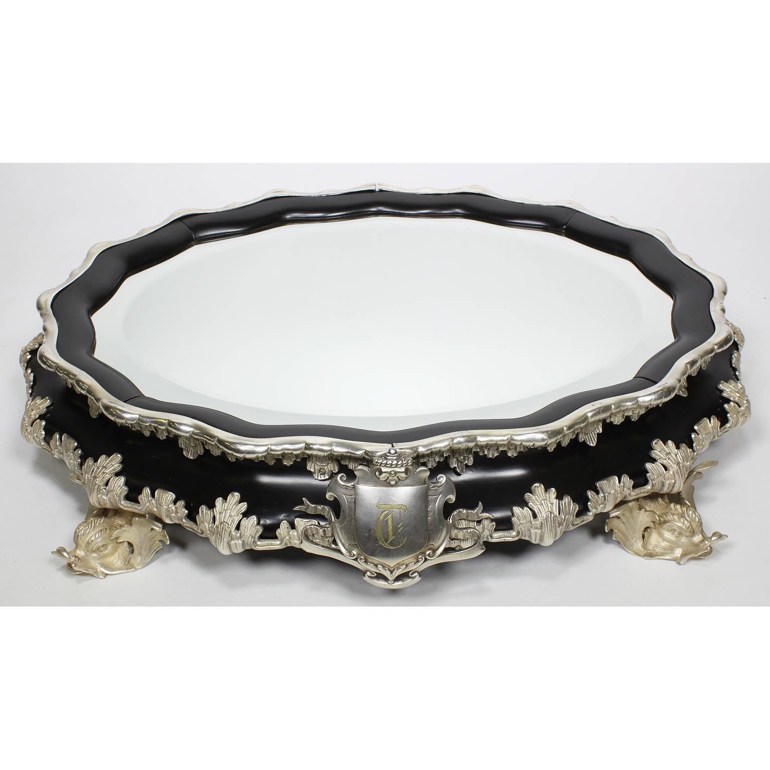 A very fine French 19th-20th century neoclassical revival style ebonized wood and figural silver plated mounted plateau Surtout de Table centerpiece in the manner of Buccellati. The ovoid shaped body surmounted with silvered bronze mount figures of