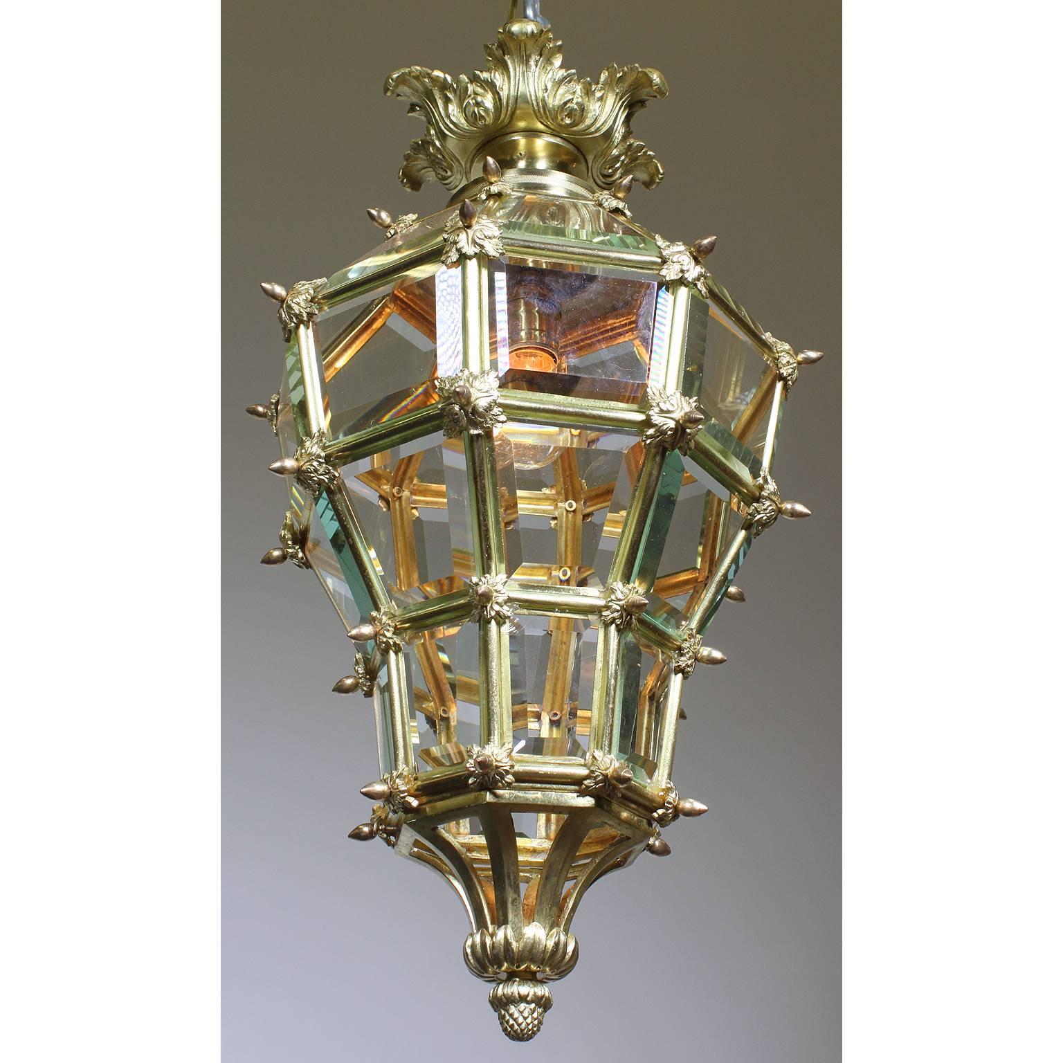 A charming French Louis XIV style early 20th century gilt bronze and paneled beveled glass 