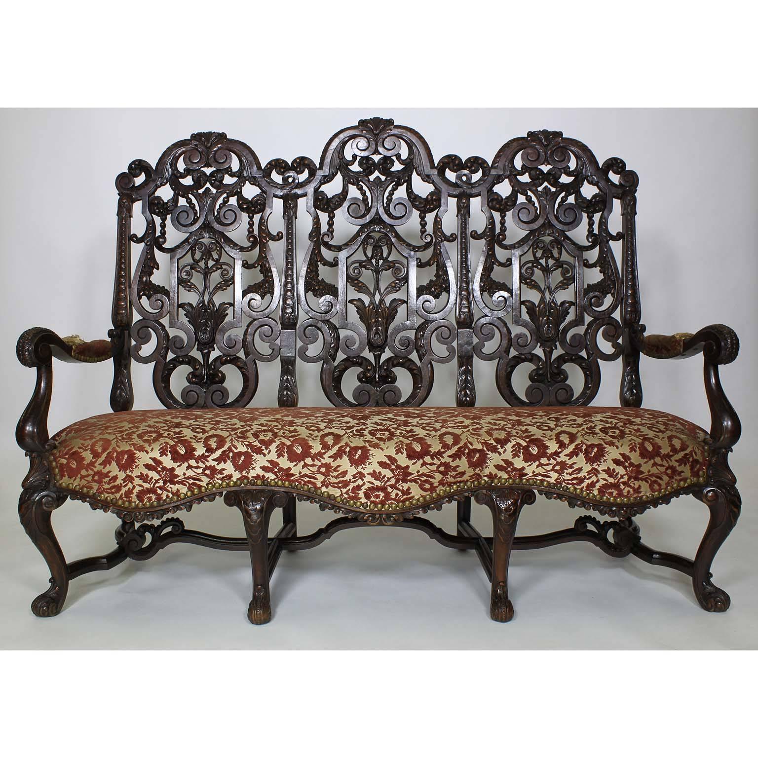 A Fine Anglo-Dutch 19th Century Baroque Style Ornately Carved Walnut Five Piece Parlor - Salon Suite, After Daniel Marot (French-Dutch, 1661–1752); comprising of a settee, two armchairs and two side chairs. The intricately pierced high-backs carved