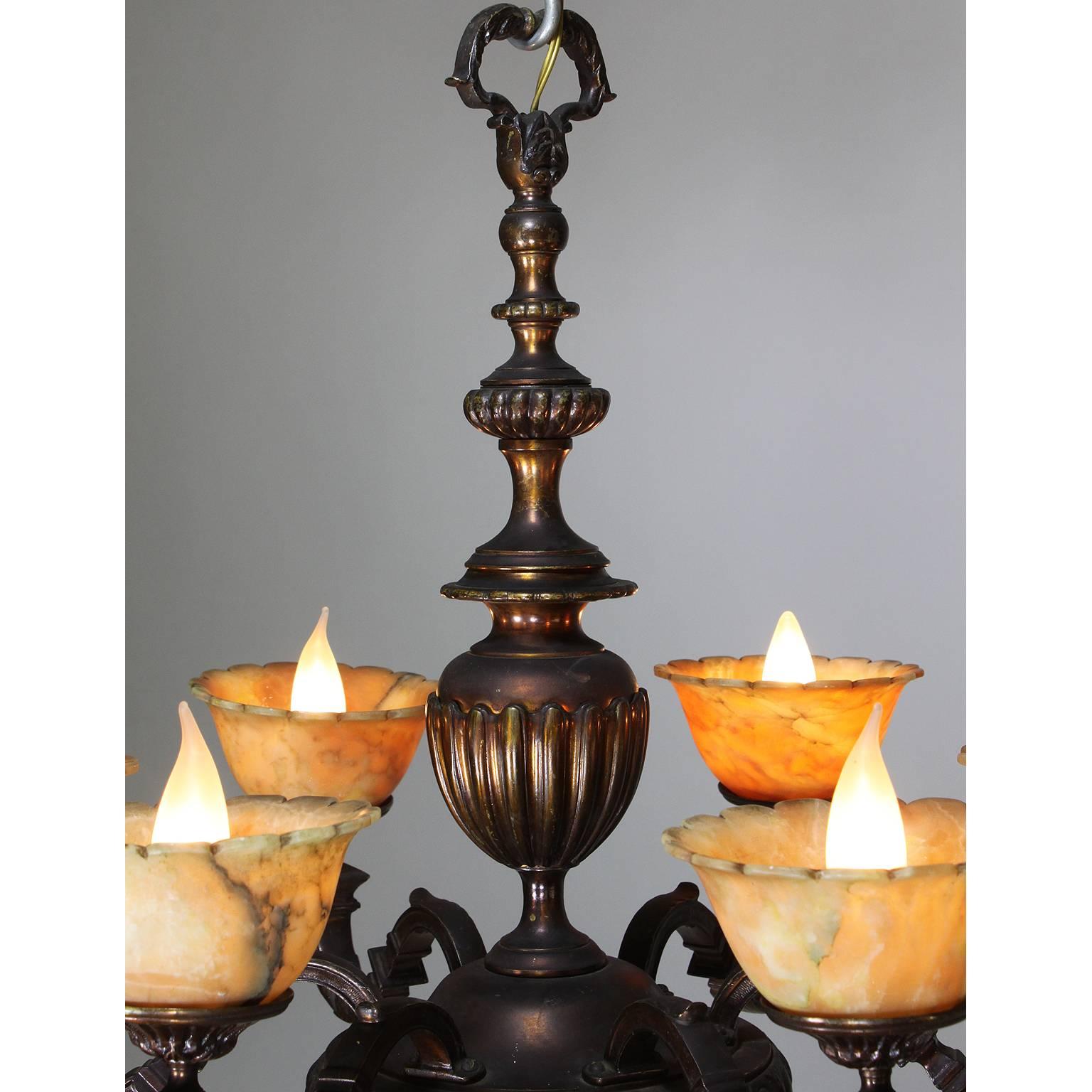 A rare French Art-Deco patinated bronze and amber alabaster six-light chandelier, Paris, circa 1920.

Measures: Height 23 1/4 inches (59.1 cm)
Width 28 1/2 inches (72.4 cm).

         