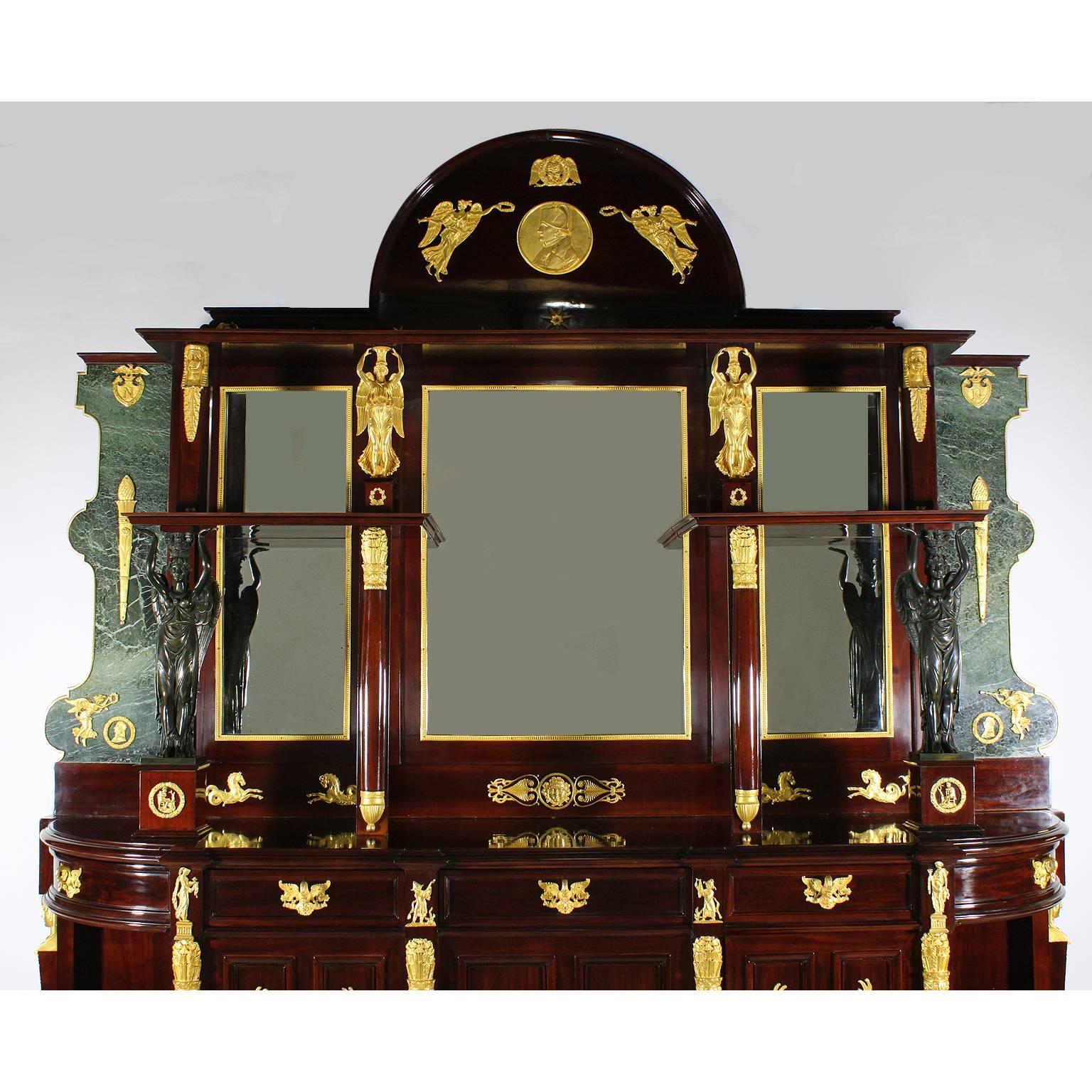 An impressive Napoleon III Empire Revival mahogany, marble, gilt bronze and patinated-bronze-mounted credenza buffet, after Pierre-Philippe Thomire (1751–1843). The large mahogany and green marble upper body with a domed top centred with a circular