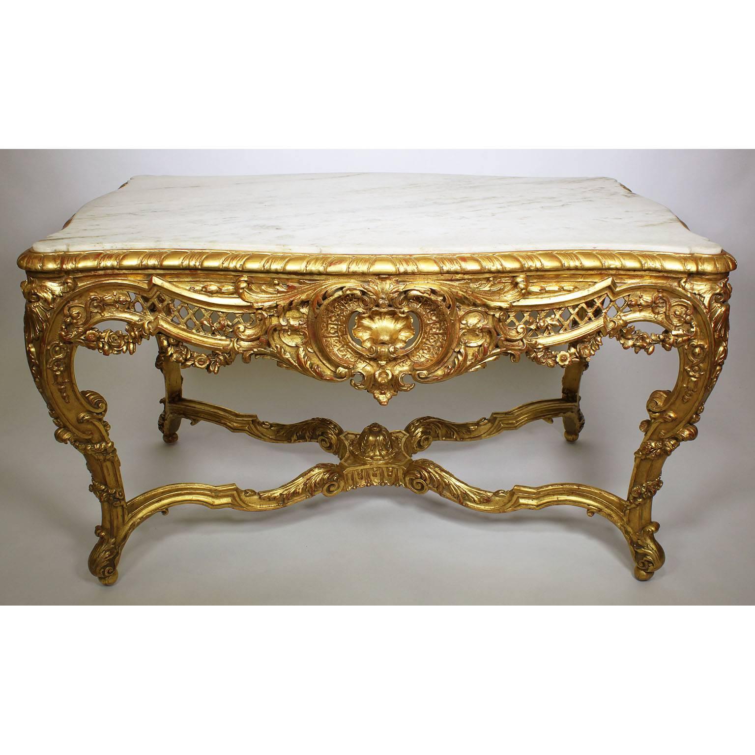A fine French Belle Époque 19th-20th century giltwood carved Rococo Louis XV style center hall table. The rectangular frame with serpentine front and sides with four cabriolet legs connected with an 