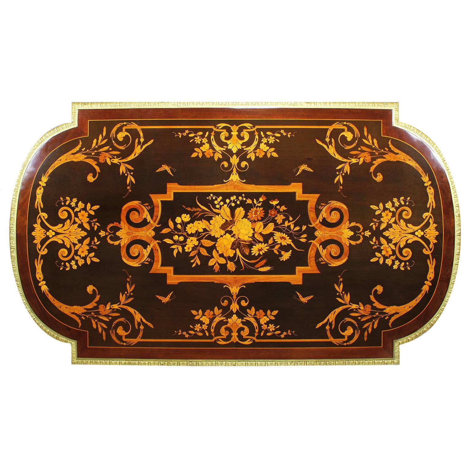 A fine French 19th century Louis XVI style ebonized gilt bronze-mounted tulipwood, kingwood and fruitwood floral marquetry single-drawer center table, desk or writing table. The ornately decorated marquetry top, centered with a floral bouquet,