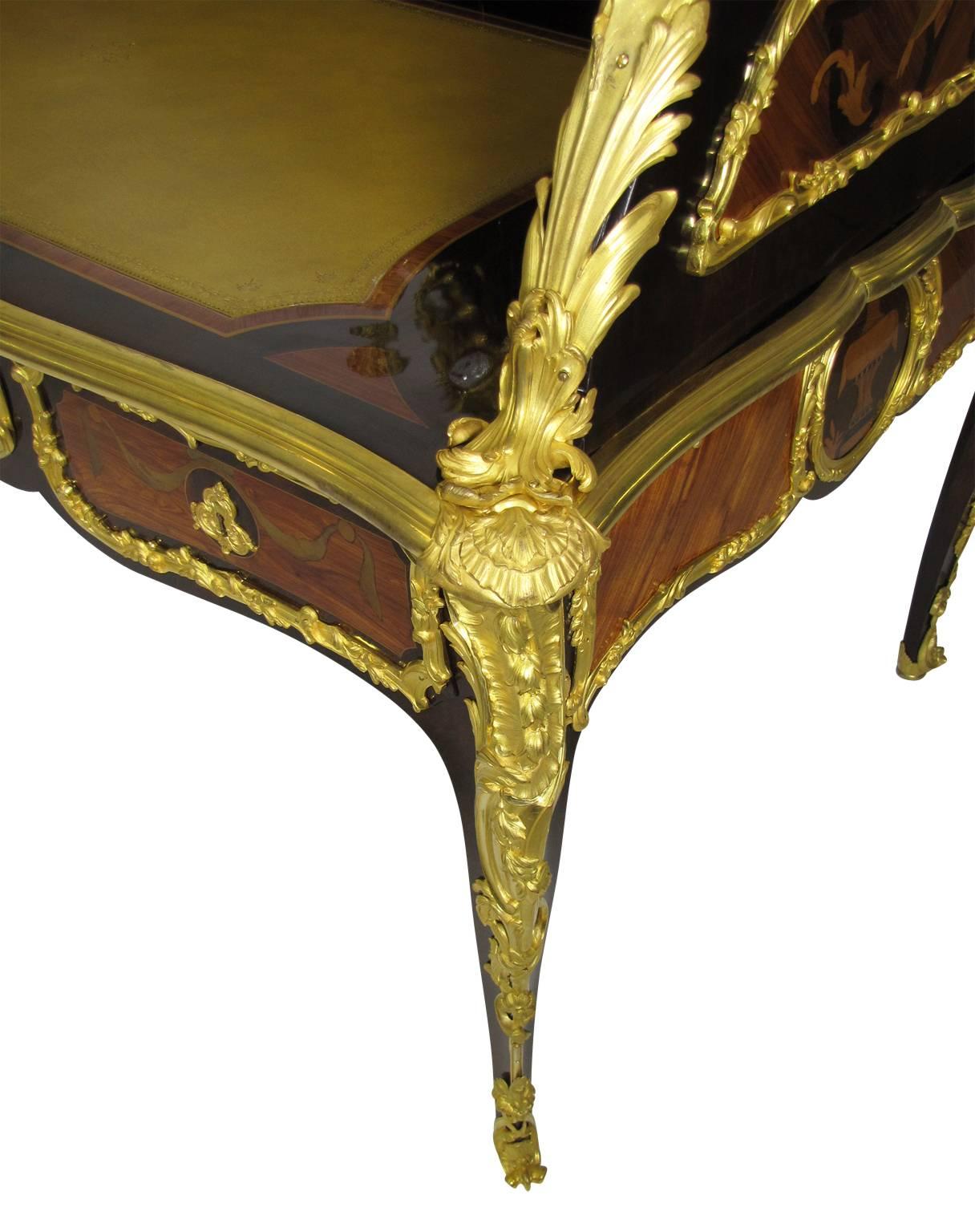 Palatial French 19th-Century Louis XV style figural gilt bronze mounted tulipwood marquetry three-drawer bureau-plat cartonnier with Dual clock-works by Lenoir, Paris, surmounted with a pair two-light gilt bronze mounted candelabra. All two-tone