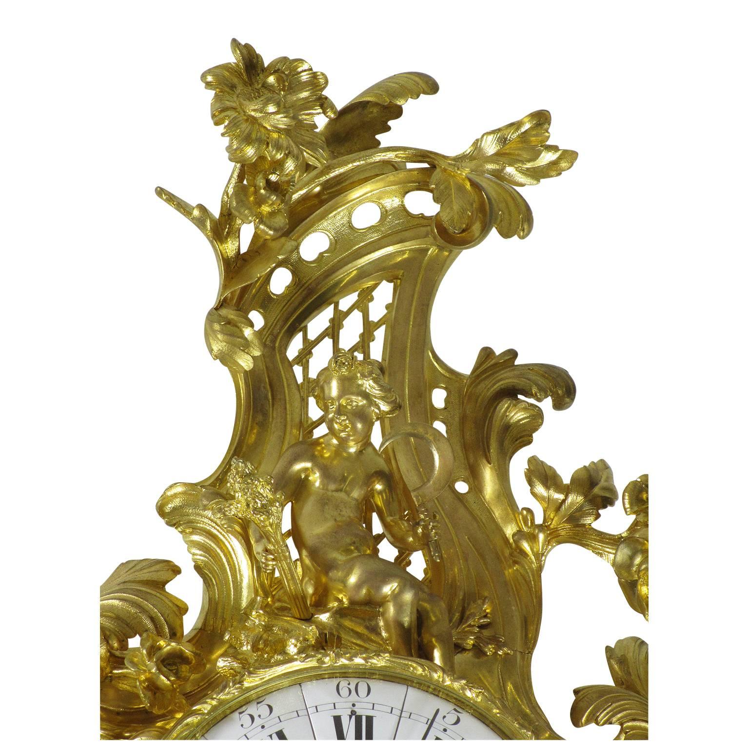 A very fine and Palatial French 19th Century Louis XV Style gilt bronze figural cartel clock by Lerolle Frères, the finely frame body with a circular face with Roman numerals, the center with a profile of King Louis XV and inscribed Lerolle