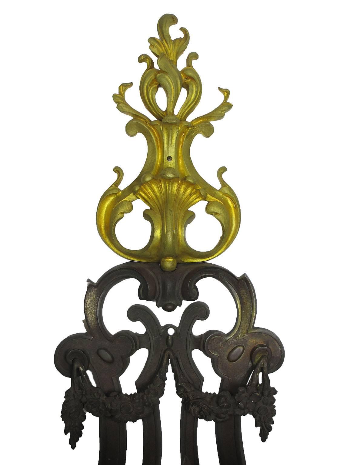 A fine and Large French Art Deco patinated and gilt bronze seven-light figural wall sconce, the impressive harp-shaped frame with the light-arms in the form of lilies, crowned with a gilt-bronze scrolled acanthus finial and a satyr mask at the