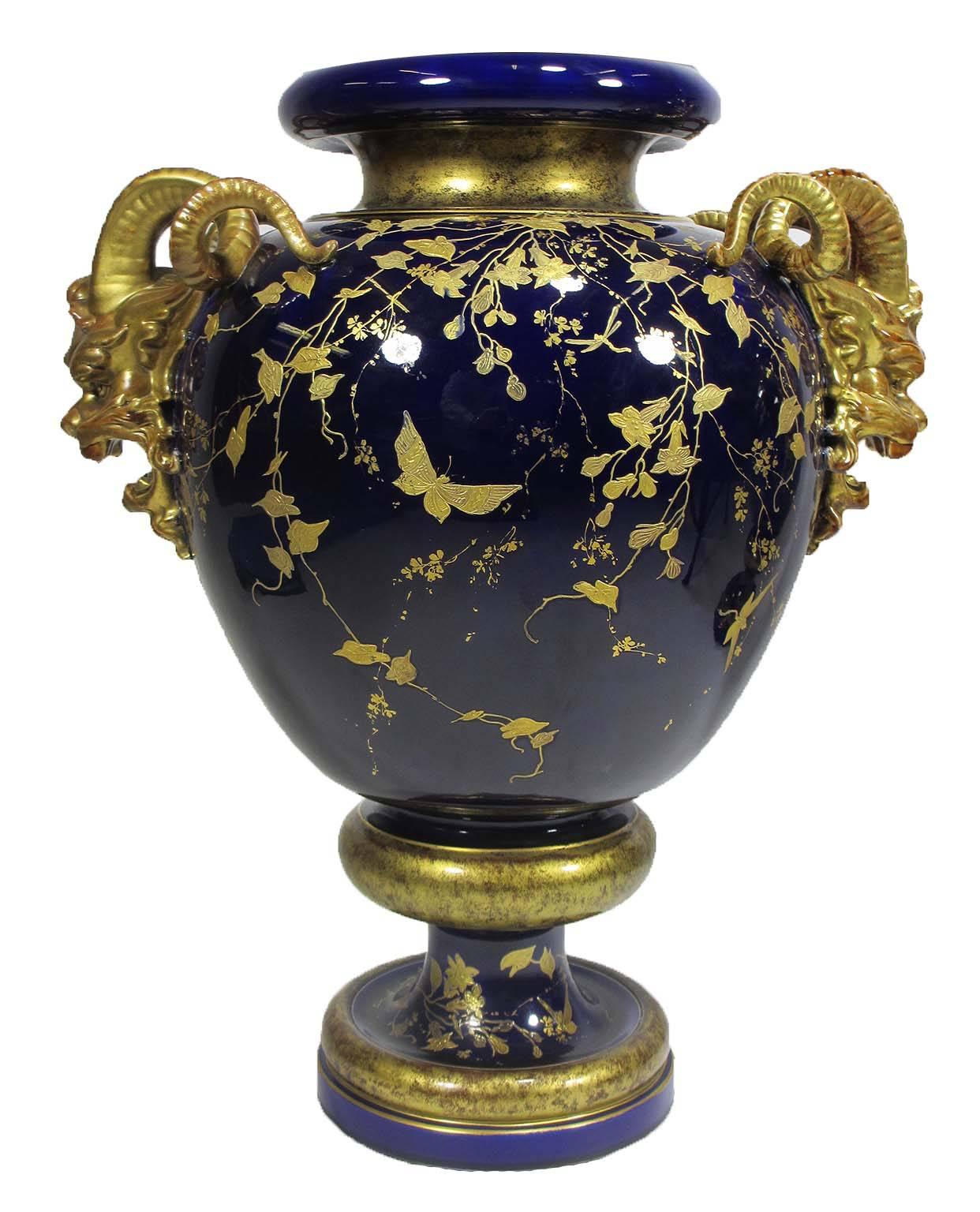 A very fine pair of 19th century cobalt-blue and parcel-gilt majolica figural vases, with figures of satyrs and gilt decorations of flowers and butterflies. Probably English, circa 1880.

Measures: Height: 24 1/2 inches (62.3 cm).
Width: 20 1/2