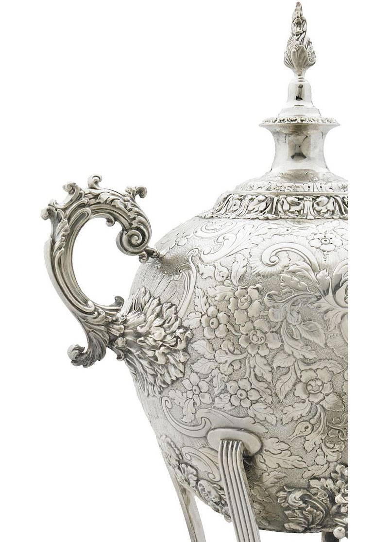A very fine English 19th century Regency style Sheffield plate hot water-tea samovar, surmounted by a turned finial and flanked by scroll handles, the body engraved with foliate and floral ornament on a stippled ground, raised on paw feet. circa:
