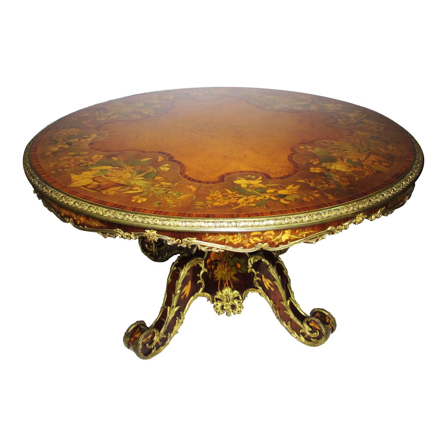 An extraordinary fine English victorian marquetry Sycamore, Amboyna, burr-walnut and ormolu-mounted circular tulipwood crossbanding tip-top center table with inlaid decorations depicting wicker baskets full of flowers, vines, butterflies and