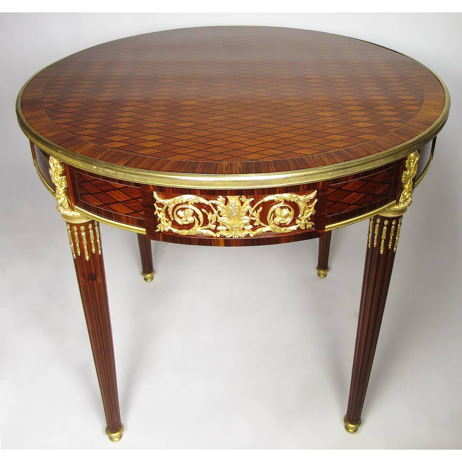 A very fine French Belle Époque 19th-20th century Louis XVI style tulipwood parquetry and ormolu-mounted guéridon (round table) with a single drawer, circa: Paris, 1900.

Height: 29 3/4 inches (75.6 cm).
Diameter: 33 1/4 inches (84.5 cm).

