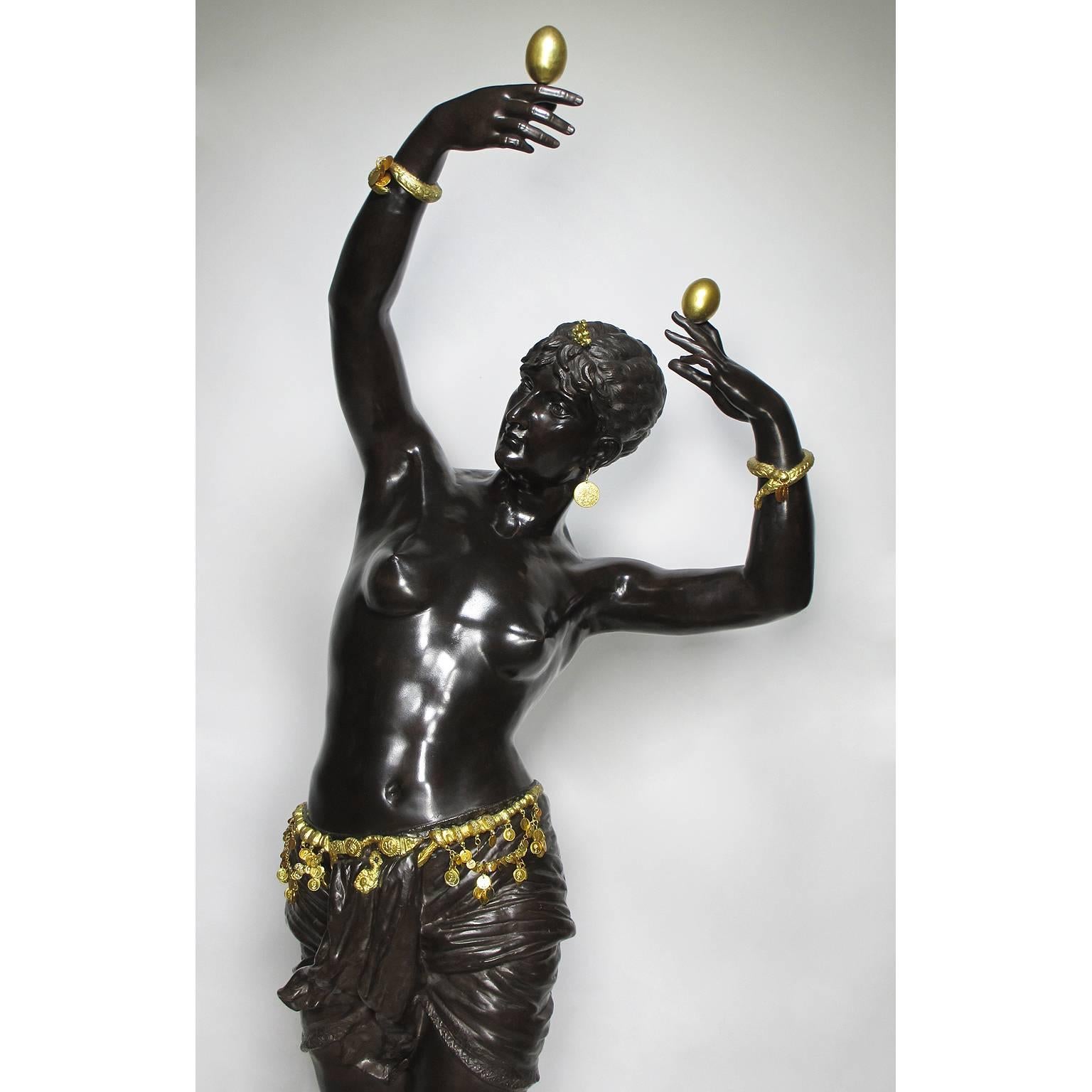 A fine and large French 19th century Orientalist style life-size patinated and parcel-gilt bronze sculpture of 