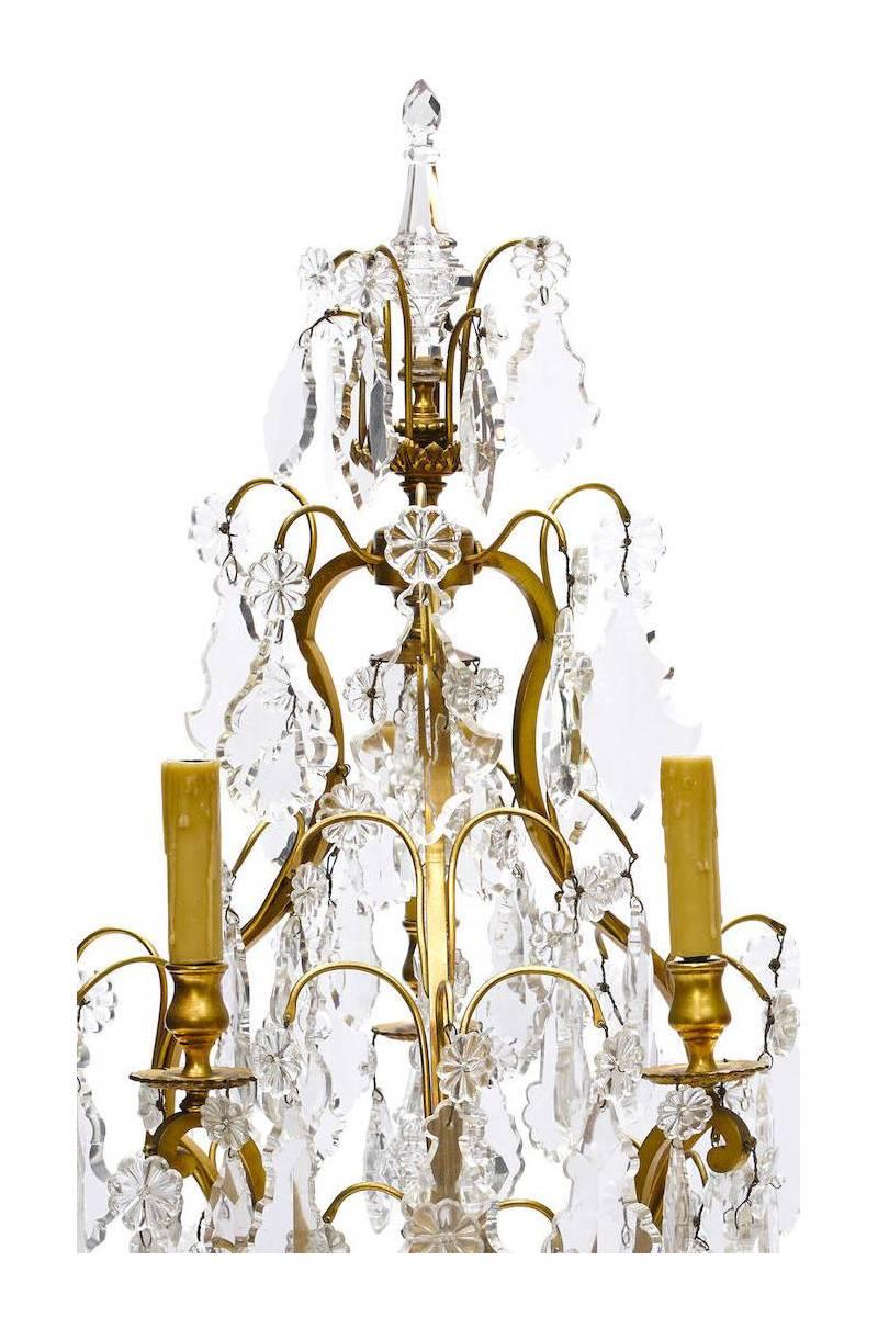 A fine pair of French 19th-20th century Louis XV style gilt bronze and cut-glass three-light Girandoles table lamps. (Electrified), Paris, circa 1900.

Height: 33 inches (84 cm).
Width: 17 inches (43.2 cm).
Depth: 17 inches (43.2 cm).

