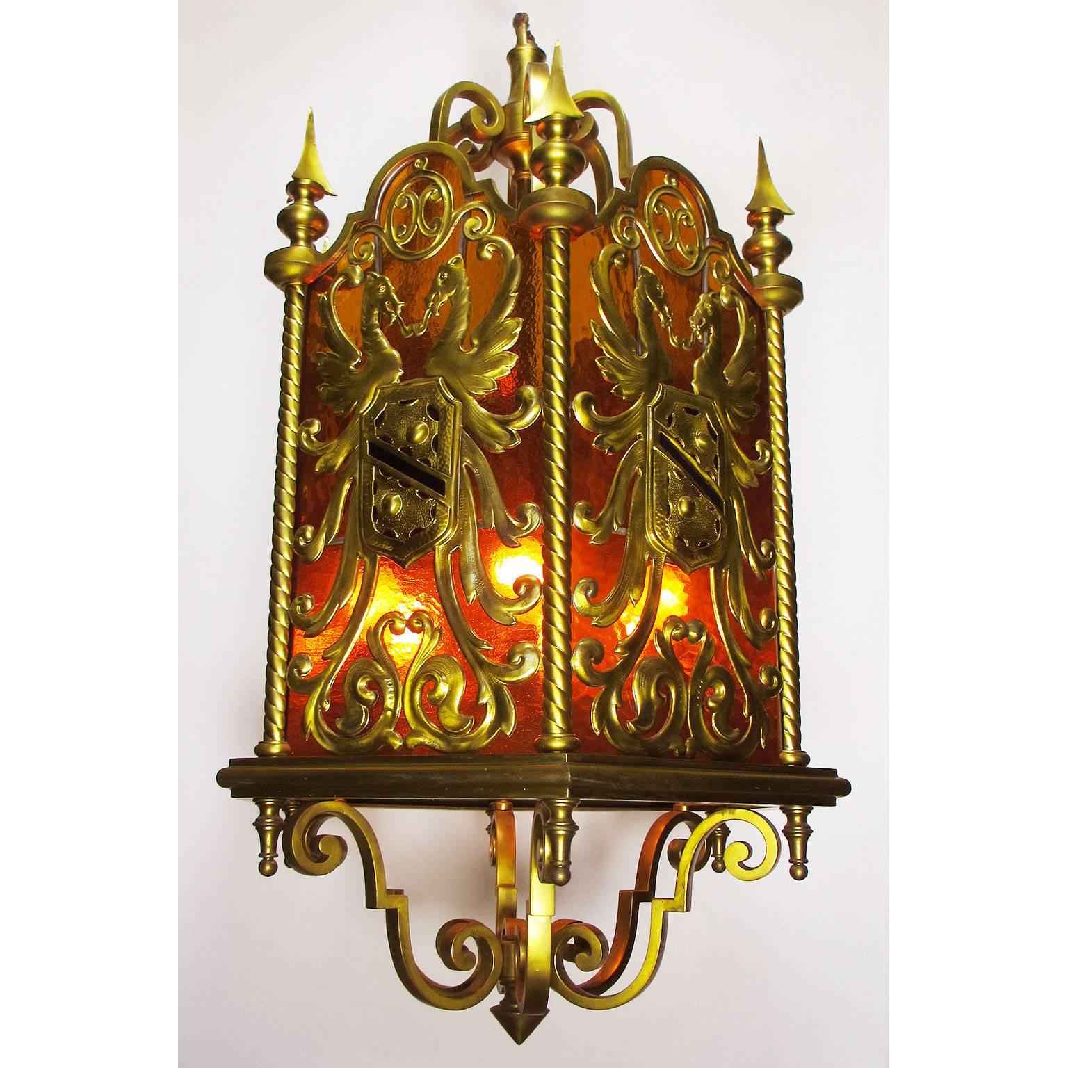 A fine and rare French 19th-20th century neoclassical style gilt bronze and color-glass figural hanging lantern, the hexagonal shaped body with an orange glass paneling background, each panel centered with a gilt bronze Royal Crest depicting