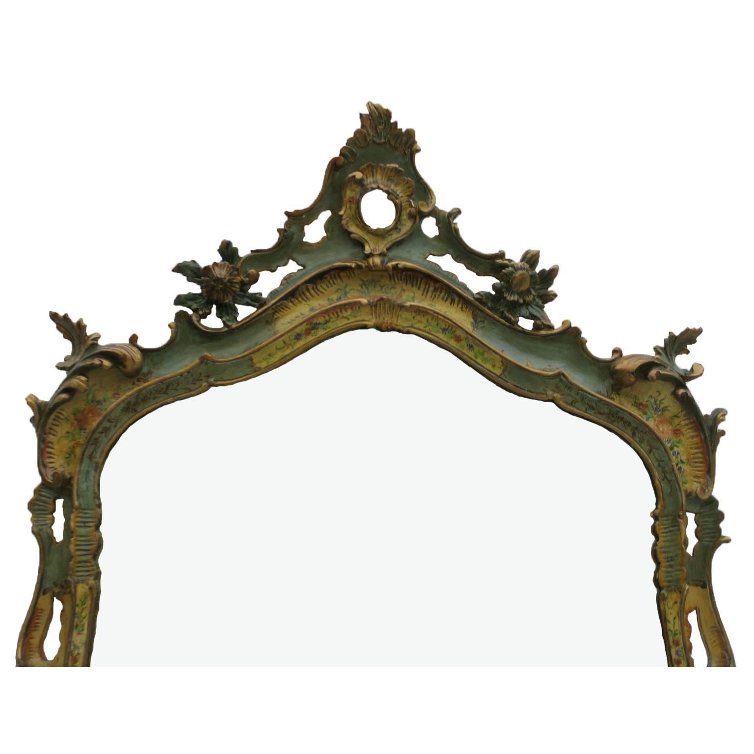 A rare Italian 19th-20th century polychrome painted and floral decorated carved wood console and mirror, the serpentine bombé form console decorated with parcel-gilt and colorful floral bouquets over a green and ivory painted background, the front