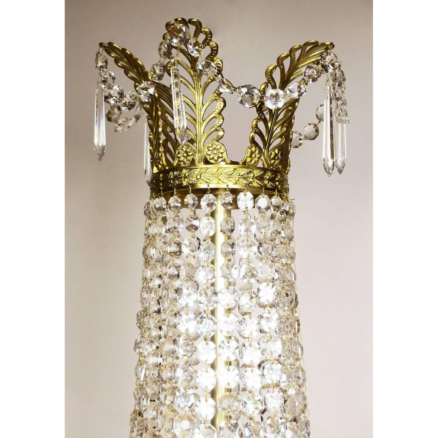 A fine French 19th-20th century Empire style gilt metal and cut-glass beaded basket style ten-light chandelier with wreaths and garlands, Paris, circa, 1900.
Measures:
Height: 41 1/4 inches (104.8 cm).
Width: 21 inches (53.4 cm).

